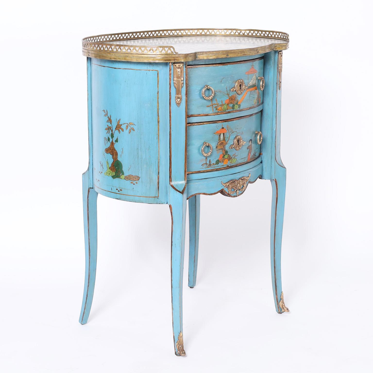 Standout French Louis XV style two drawer stand with a marble top surrounded by a brass gallery over a case with an alluring blue finish decorated with chinoiserie and brass ormolu.