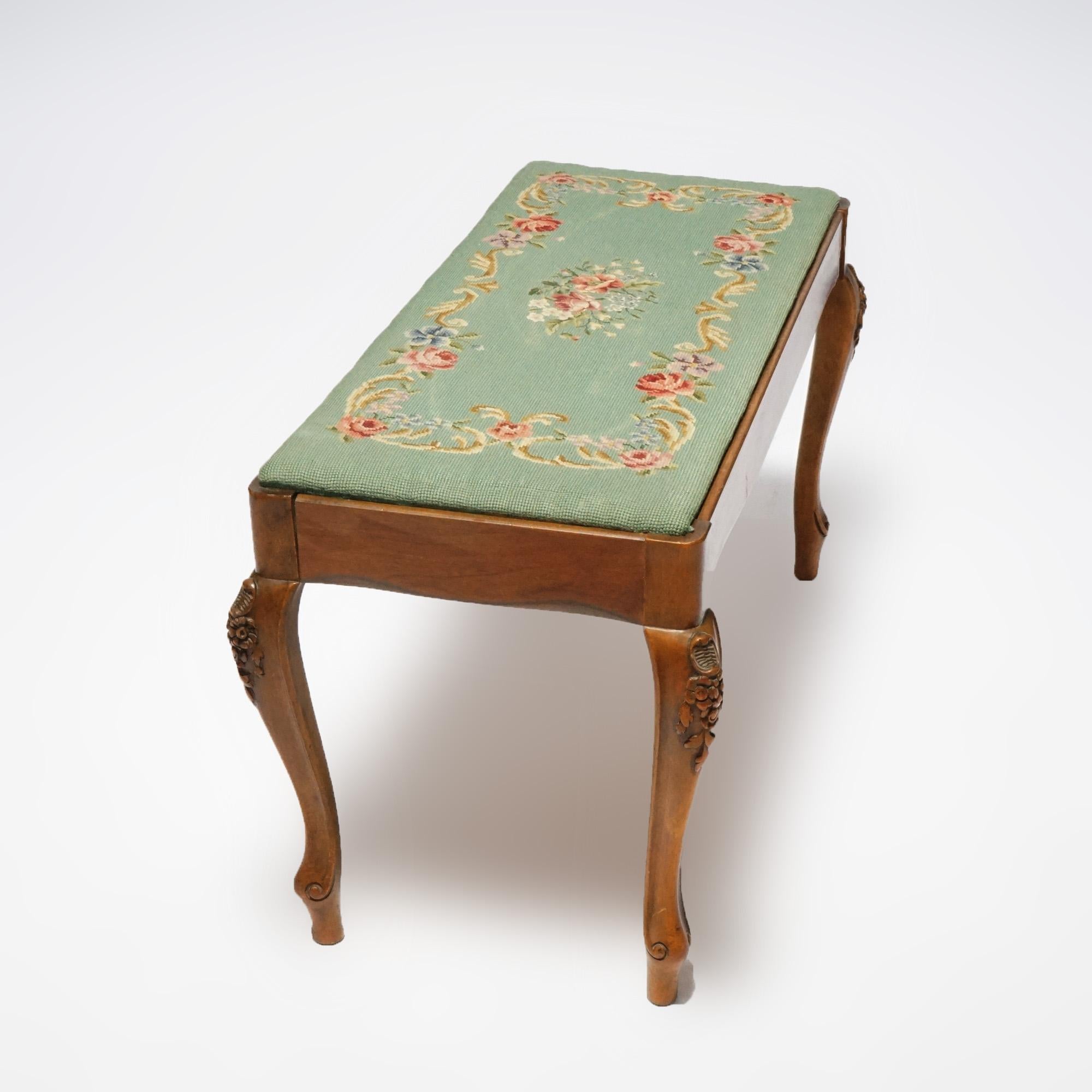 An antique French Louis XV style bench offers floral needlepoint upholstered seat over storage storage compartment raised on cabriole legs with carved knees, c11930

Measures- 17.5''H x 16.75''W x 36''L.
 