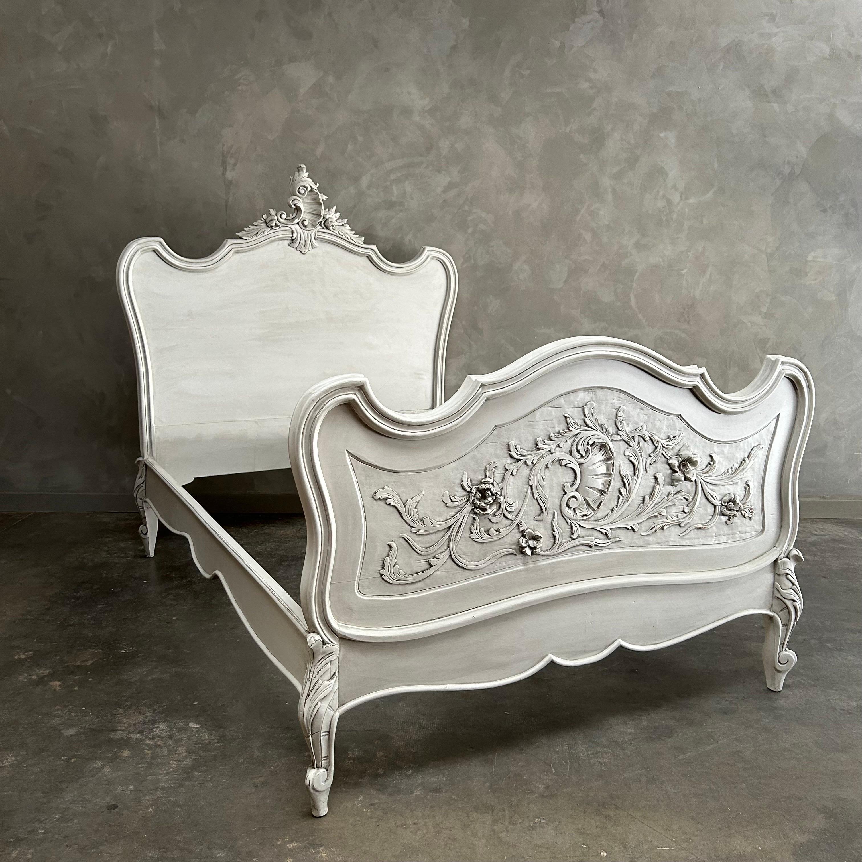 Antique Carved french bed 
Painted in a soft oyster white finish, with subtle distressed edges and antique glazed patina.
Dimensions: 58”w x 80”d x 62”h
Footboard: 39”h. 
Inside: 50.5”w x 76”d
Solid and sturdy when assembled, fits a custom size