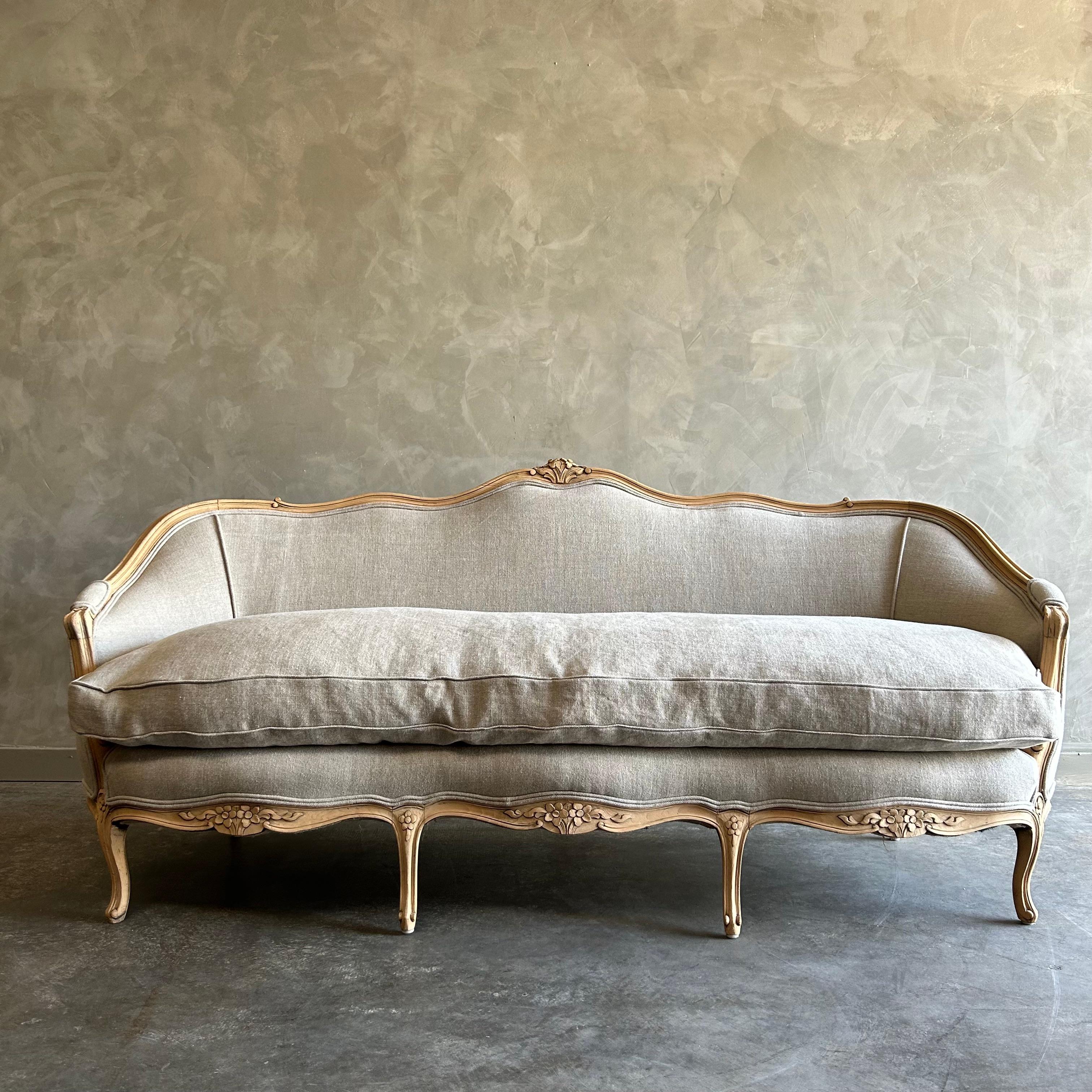 Antique French Louis XV style sofa 
Size: 78”w x 31”d x 35”h 
Seat Height :19”
Seat Depth :22”
Arm Height:24”
Beautiful French style sofa in a weathered aged oak finish. The frame has been stripped of its finish, leaving a beautiful antique