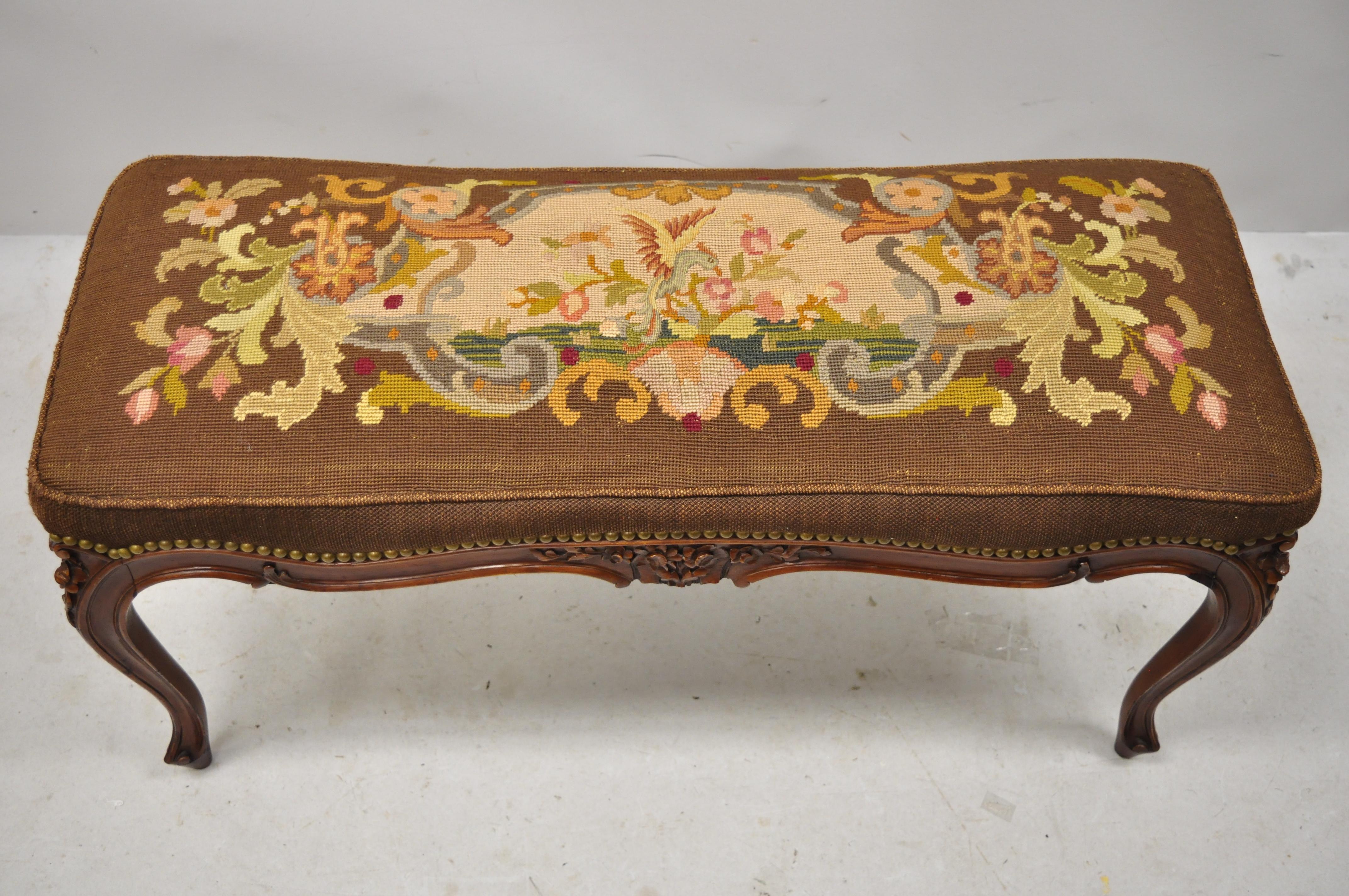 Antique French Louis XV style Victorian carved mahogany needlepoint brown bench. Item features a figural upholstered needlepoint seat, solid wood frame, nicely carved details, cabriole legs, very nice antique item, great style and form, circa early