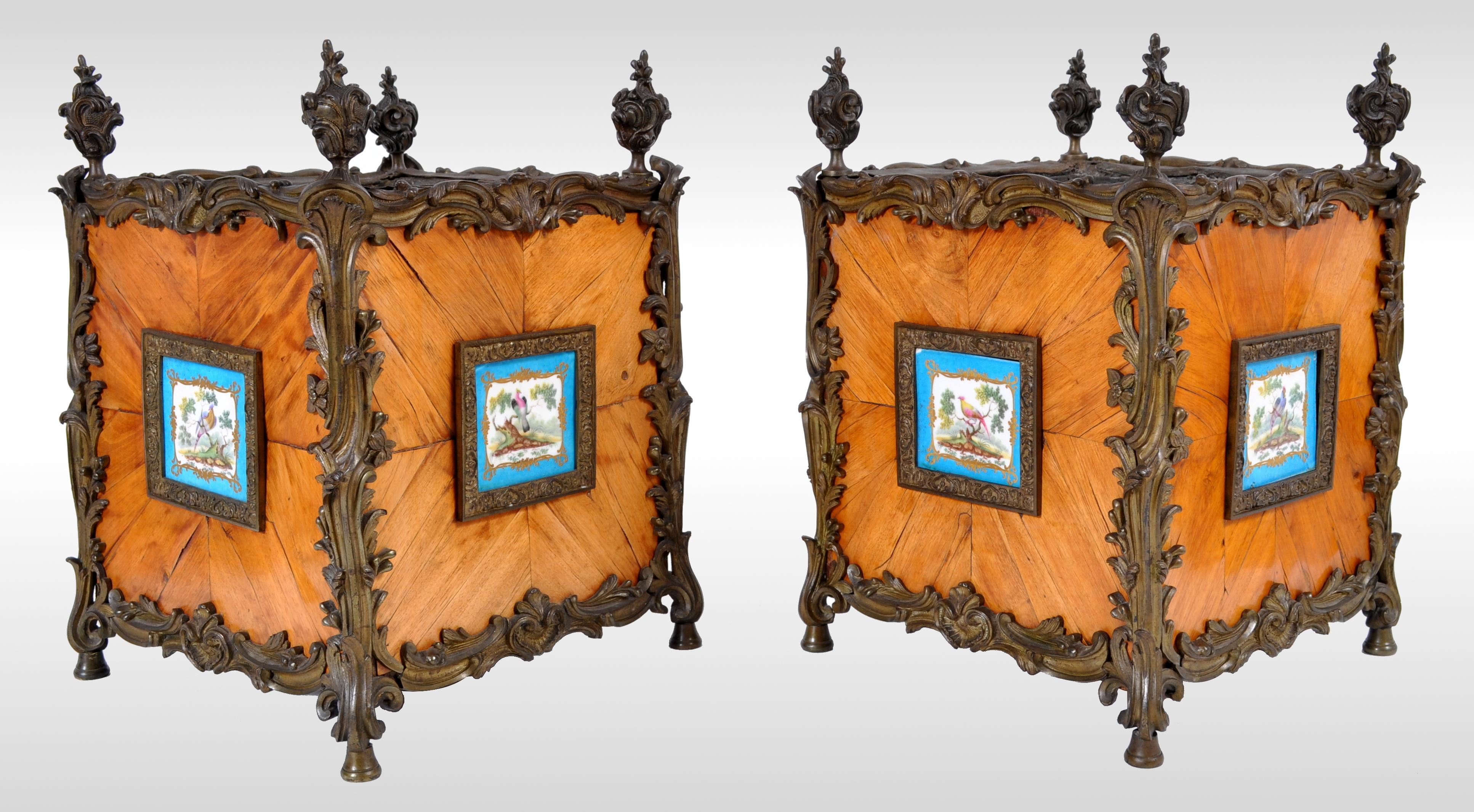 Pair of antique French Louis XV Tulipwood and Sèvres Porcelain jardinières / Planters, circa 1870. The planters having bronze flame finials and Rococo gilded bronze mounts, each side having a feather-banded tulipwood panel inset with Bleu Celeste
