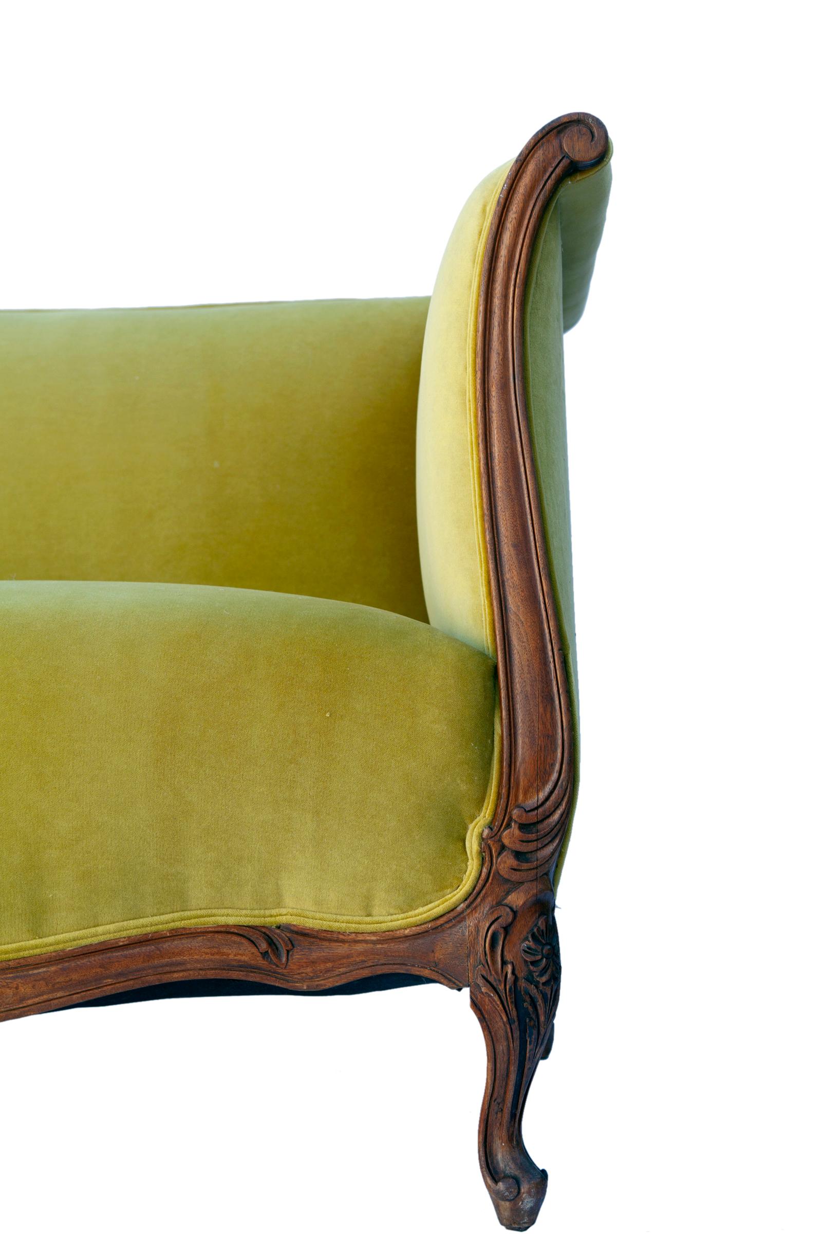 Stunning French antique Louis XV sofa hand carved frame in walnut even arm canape sofa, reupholstered in low pile Italian cotton velvet in chartreuse by Clarence House.
Hand carved floral details: scrolled arms, acanthus leaves, scalloped skirt. The