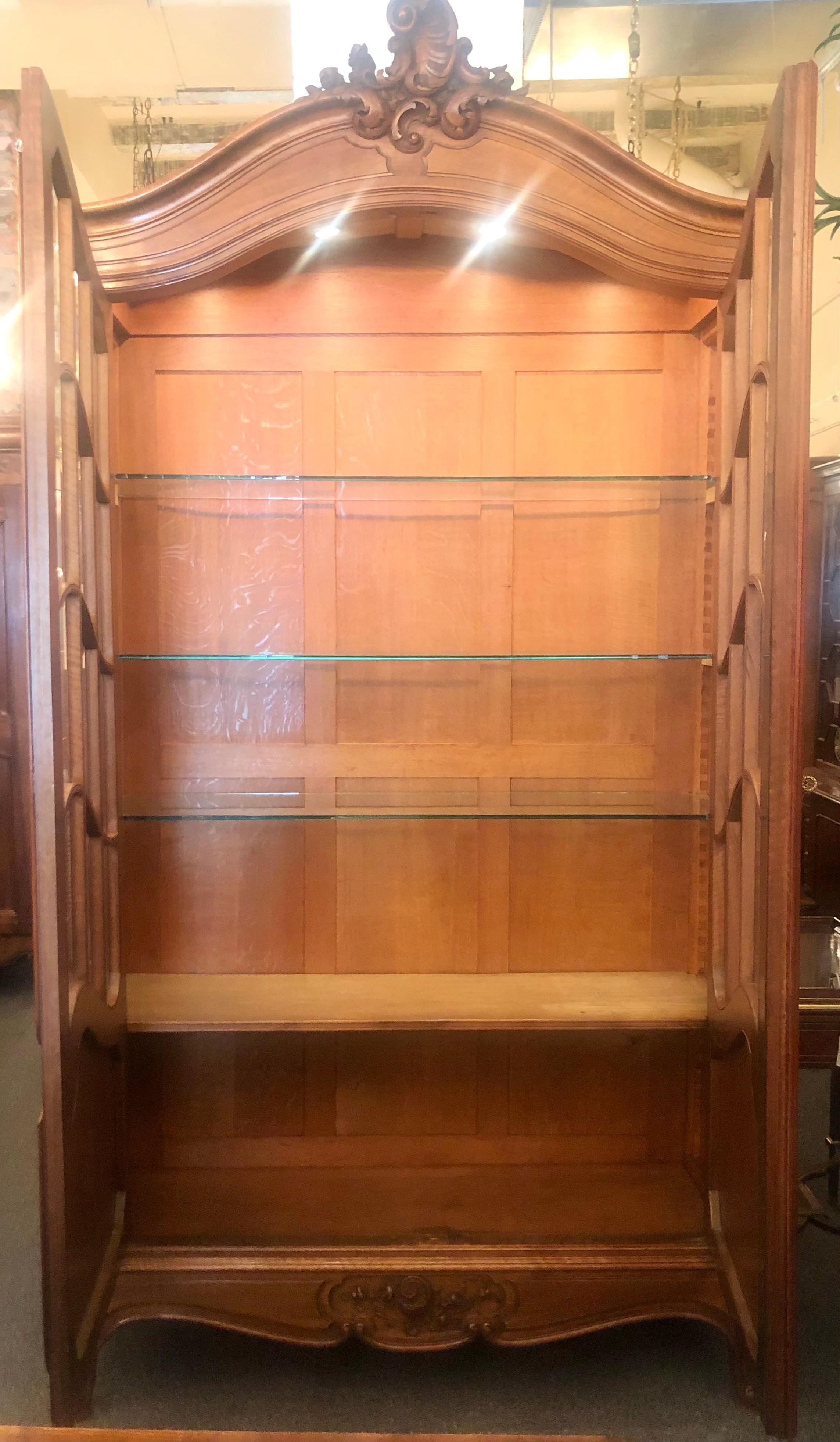 Antique French Louis XV style carved walnut and beveled glass two door display cabinet, circa 1880's.