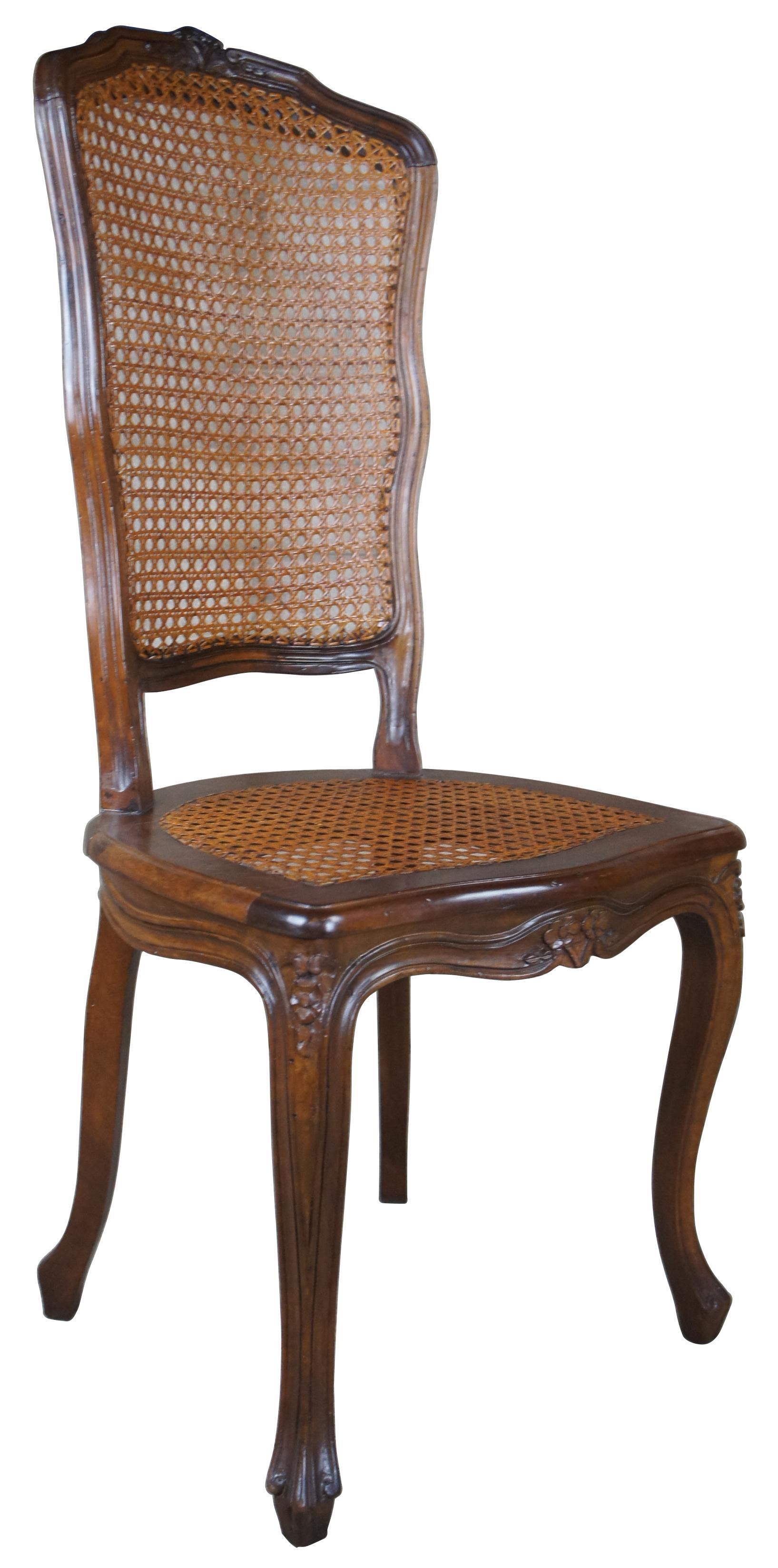 Antique French Provincial highback dining or side chair. Made from walnut with foliate carvings, caned seat/backing and canbriole legs. 
  