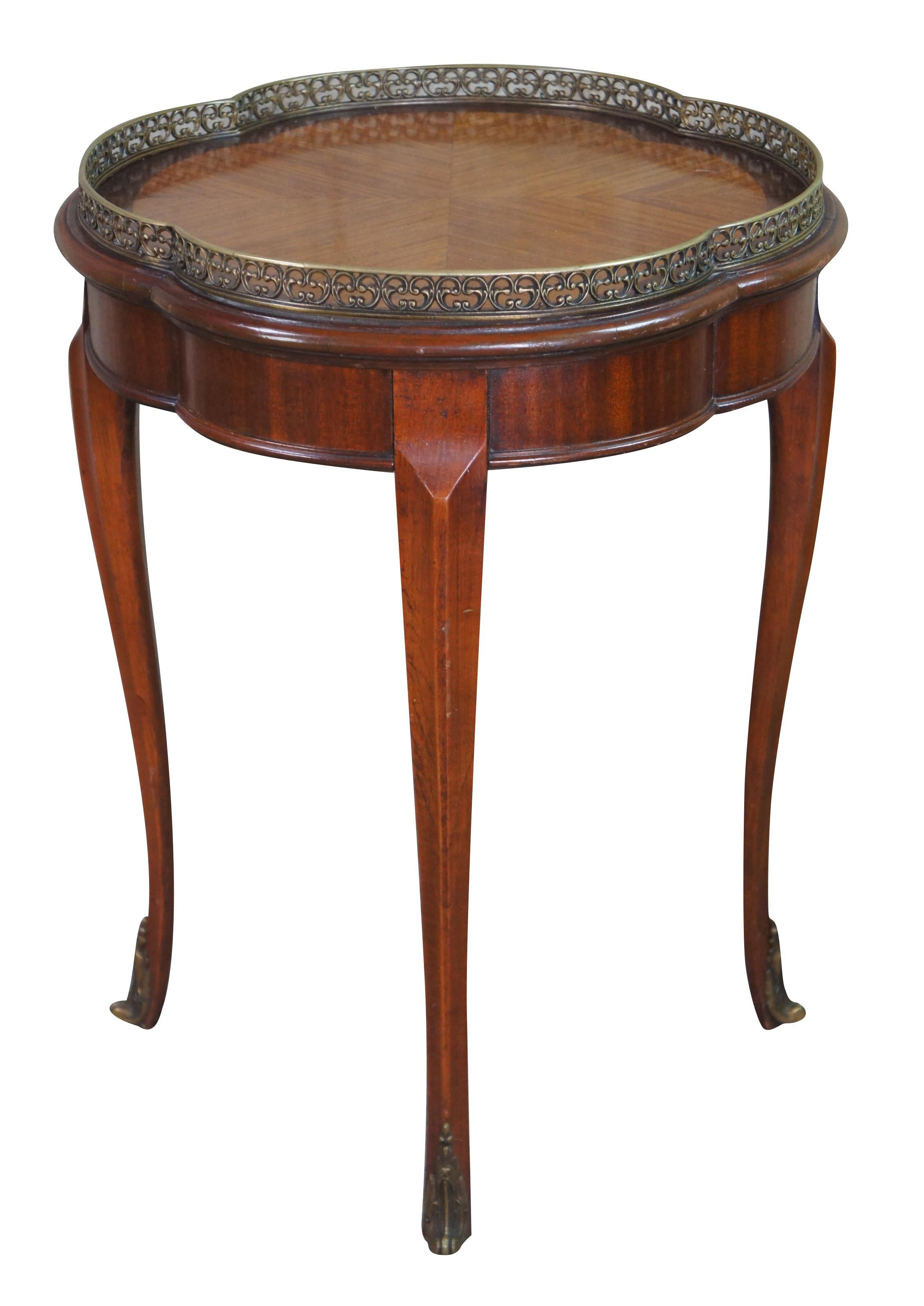 Antique French Louis XV Gueridon or Bouillette table featuring an oval serpentine / clover form with reticulated brass gallery, matchbook top and tapered cabriole legs with brass feet caps.
 