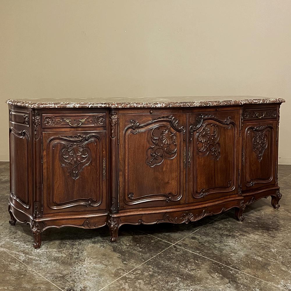 Antique French Louis XV walnut marble top Serpentine buffet is a marvelous example of the style, rendered in prized indigenous French walnut, and topped with exquisitely veined rouge marble! The entire facade, including the sides, is of a serpentine