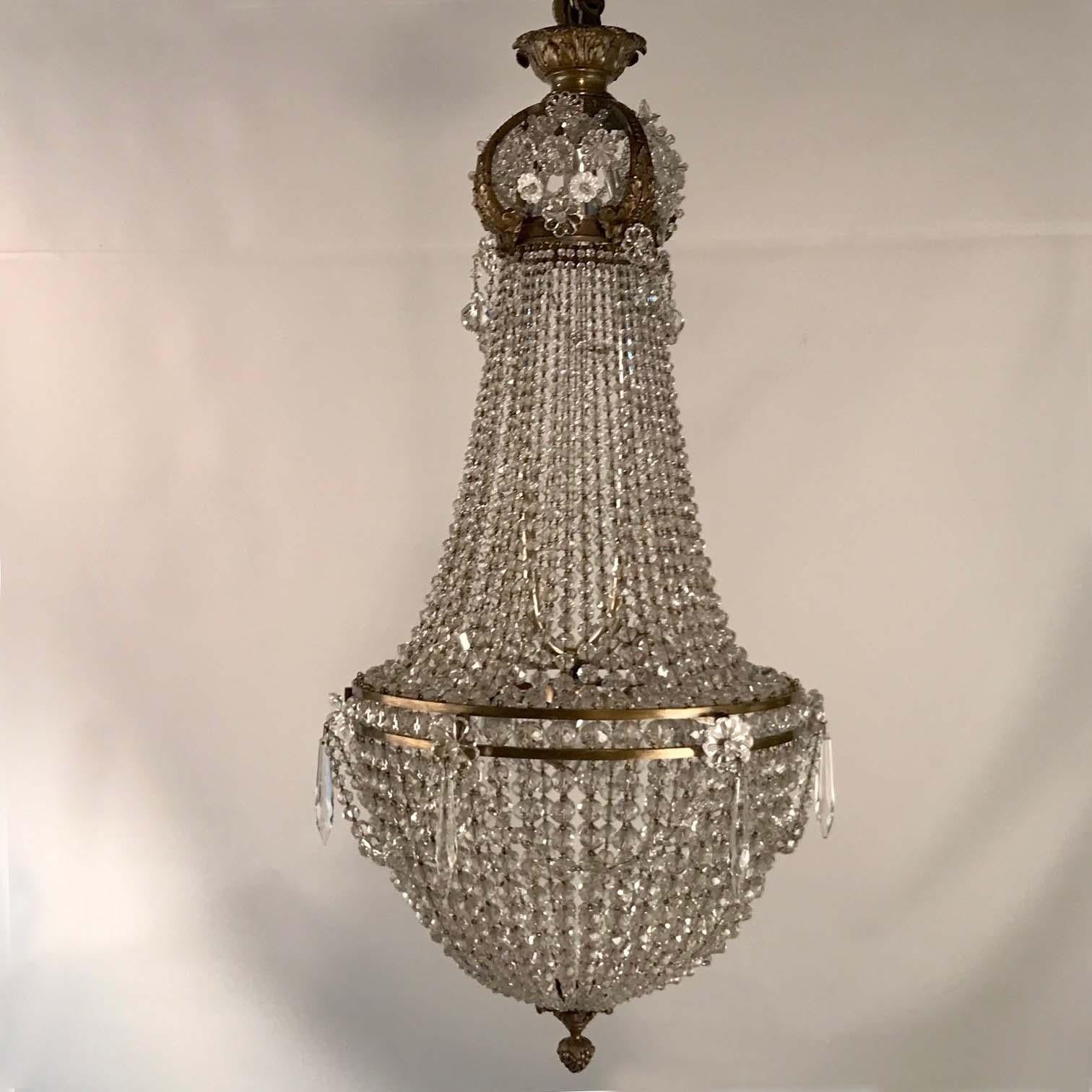 The hemispherical bag is formed with cut beads of graduated size. Descending from the bonnet-shaped crown, swags of graduated cut beads complete the glittering effect Often this type of chandelier tends to be large and heavy .This is an