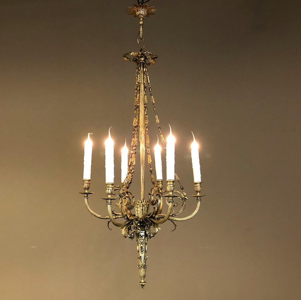 Le lustre français ancien de style Louis XVI en bronze est un design spectaculaire, inspiré de l'architecture antique grecque et romaine ! Le baldaquin d'origine est toujours là, moulé pour représenter une rosette de laurier, qui conduit le regard