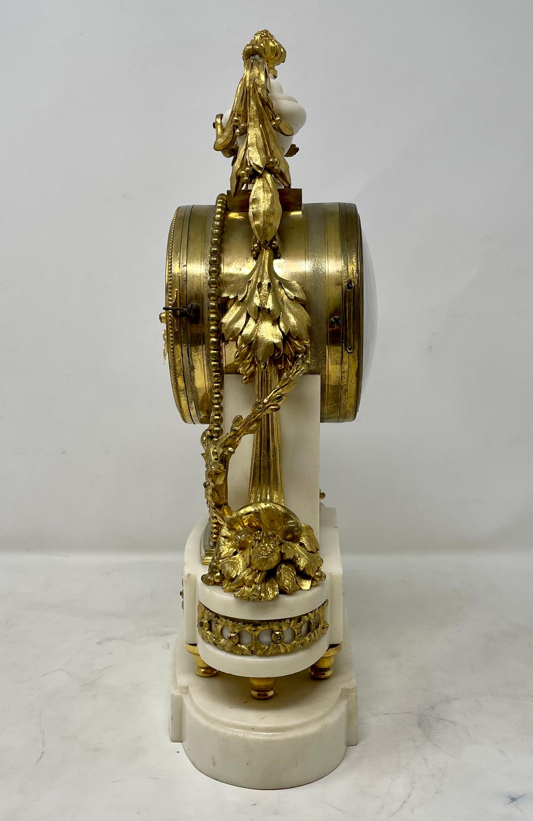 Antique French Louis XVI carrara marble and gold bronze mantel clock, circa 1880.