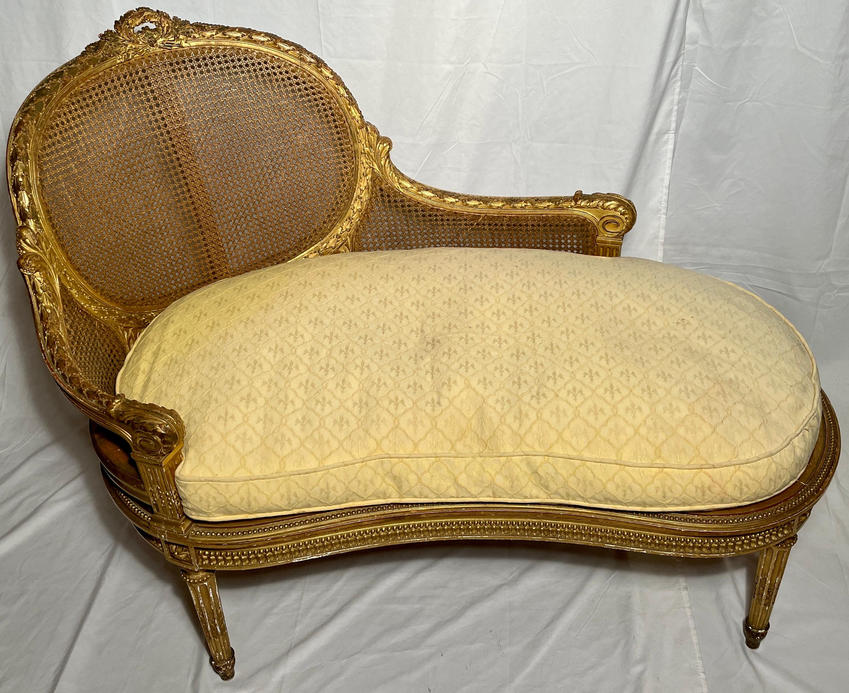 Antique French Louis XVI carved gilt wood and cane recamier or chaise lounge, circa 1890.  With Yellow Upholstered Cushion.