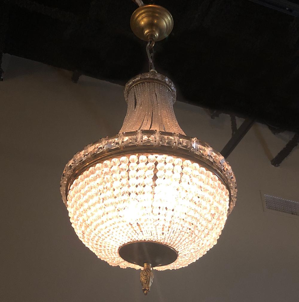 Antique French Louis XVI crystal sack of pearls chandelier is a timeless ode to the revival of the styles founded by the ancient Greeks and Romans thousands of years ago! Utilizing brass and crystal, the artisans created the graceful teardrop form