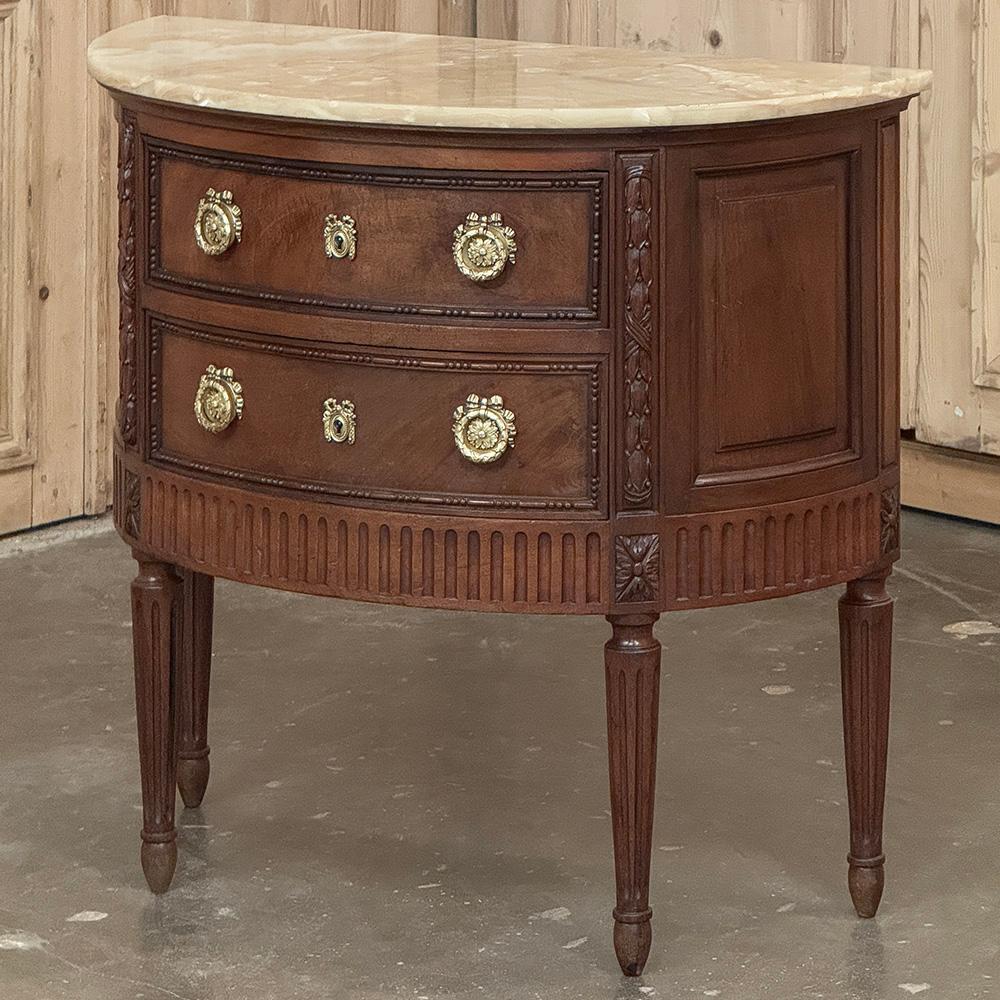 Antique French Louis XVI Demilune Commode with Onyx Top combines timeless classic style with exceptional quality in a visually pleasing form.  The demilune shape allows it to be placed in high-traffic areas as there are no sharp corners in the