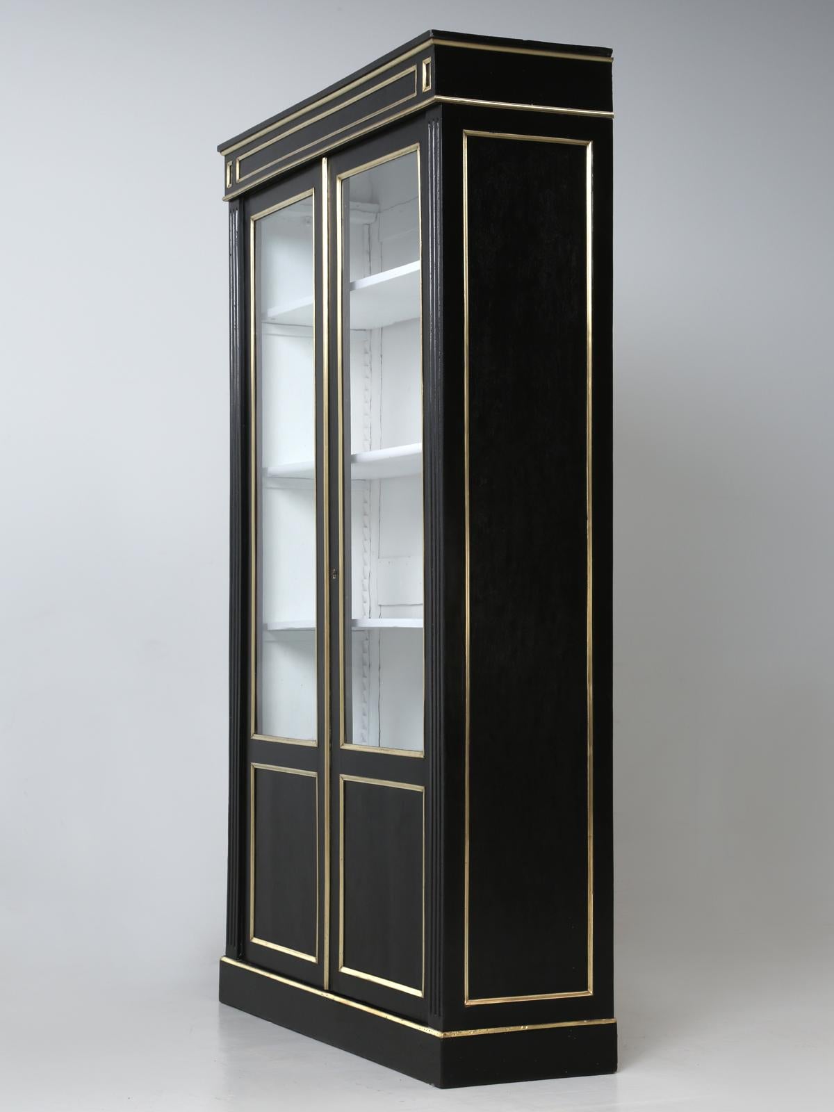 Antique French Louis XVI ebonized Bibliotheque or bookcase, that our Old Plank workshop has painstakingly disassembled and stripped by hand, with no harsh chemicals down to the bare mahogany. Likewise, each brass component was removed and cleaned