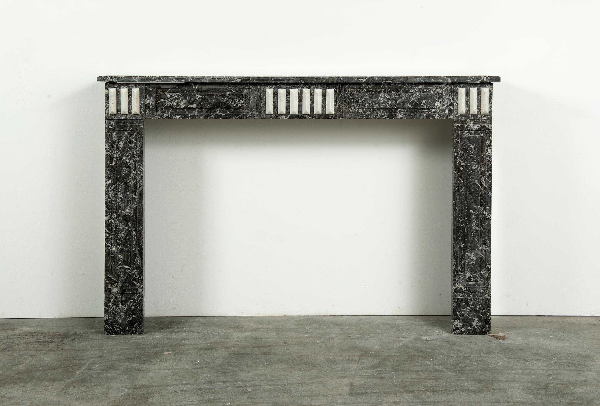 Antique French Louis XVI fireplace Mantel

A nice wide and decorative French Louis XVI executed in grey Saint Anne marble with Carrara white marble decorations.

The rectangular and profiled topshelf sits above a straight paneled freeze that is