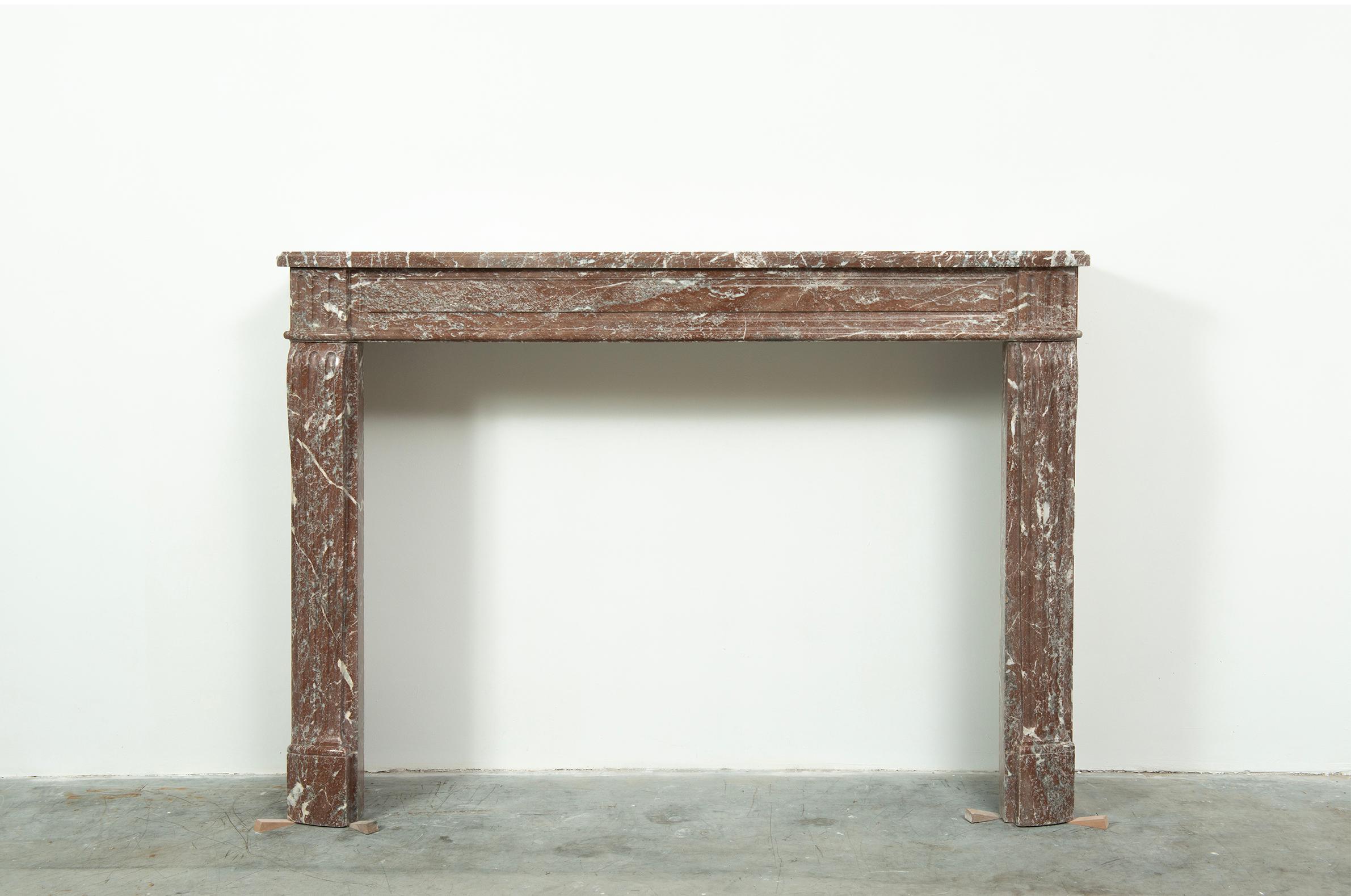 Antique French Louis XVI Fireplace Mantel.

A nice style correct Louis XVI Fireplace from Paris in France.
The profiled topshelf has a nice subtle rounded shape above the paneled frieze with fluted endblocks above curved, fluted and rounded jambs