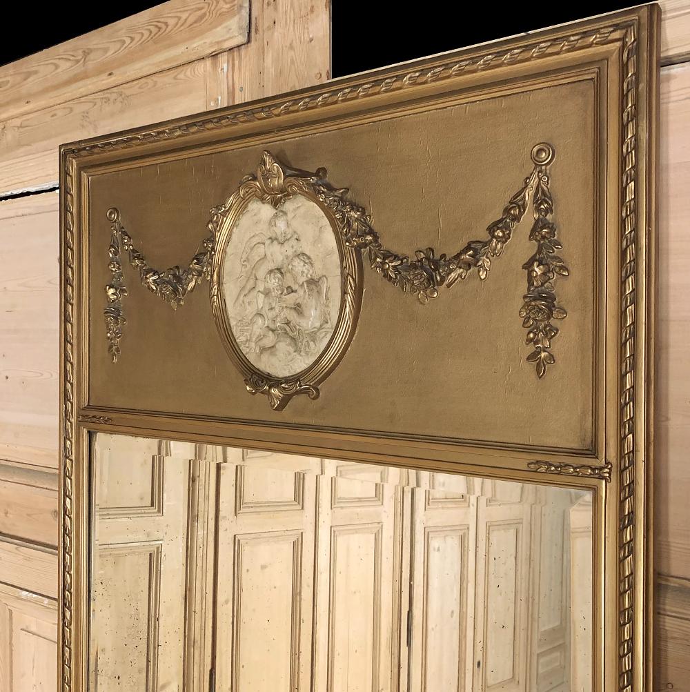 Antique French Louis XVI gilded trumeau with cameo is a remarkable work of art that serves the dual purpose of reflecting ambient light! An understated elegance is defined by the classical architecture of the piece, trimmed all around with spiral
