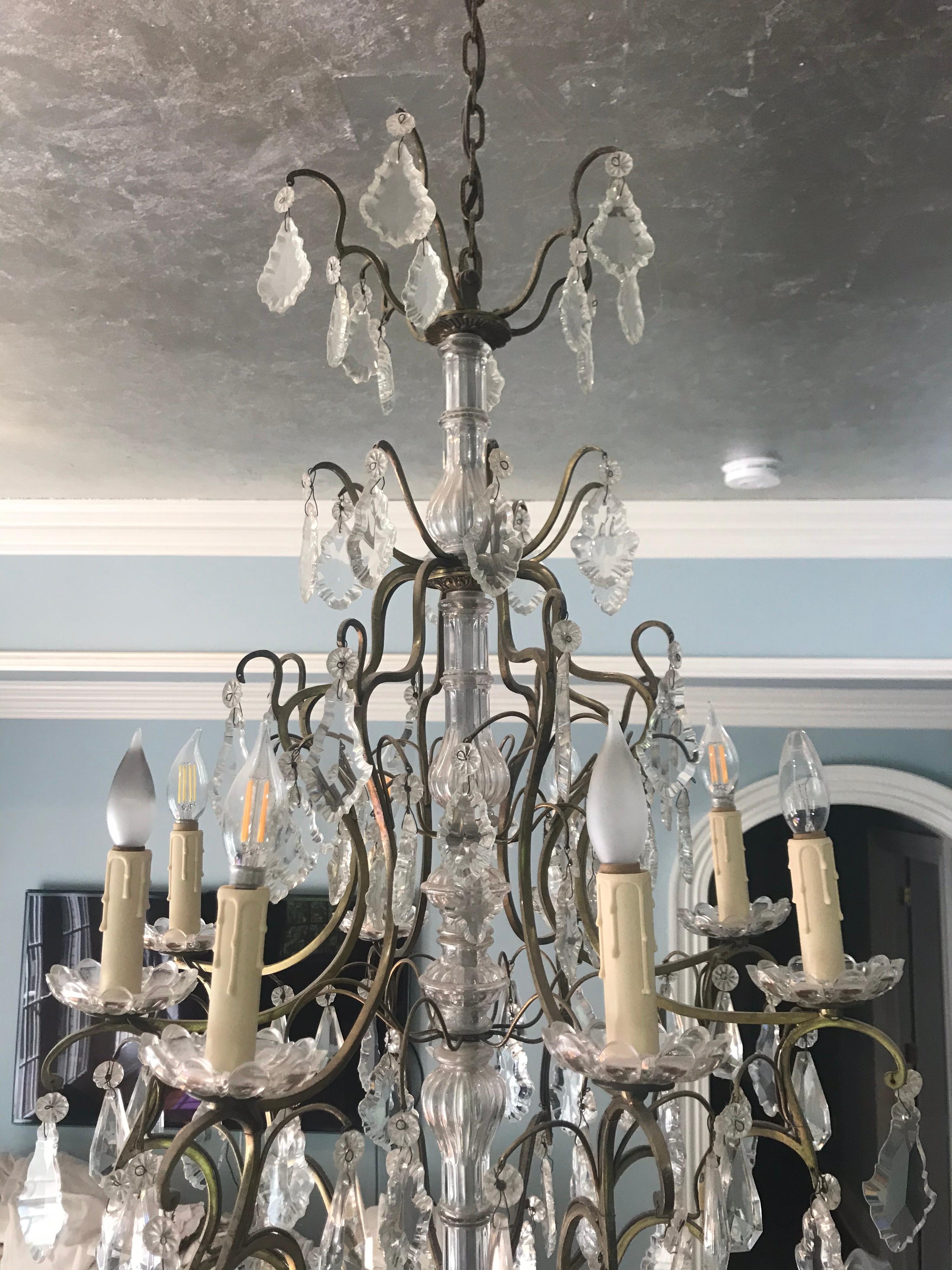 Gorgeous early 19th century French Louis XVI style finely cut crystal and bronze gilt eight-light chandelier with unique cut crystal center shaft. This chandelier will add elegance to any room.