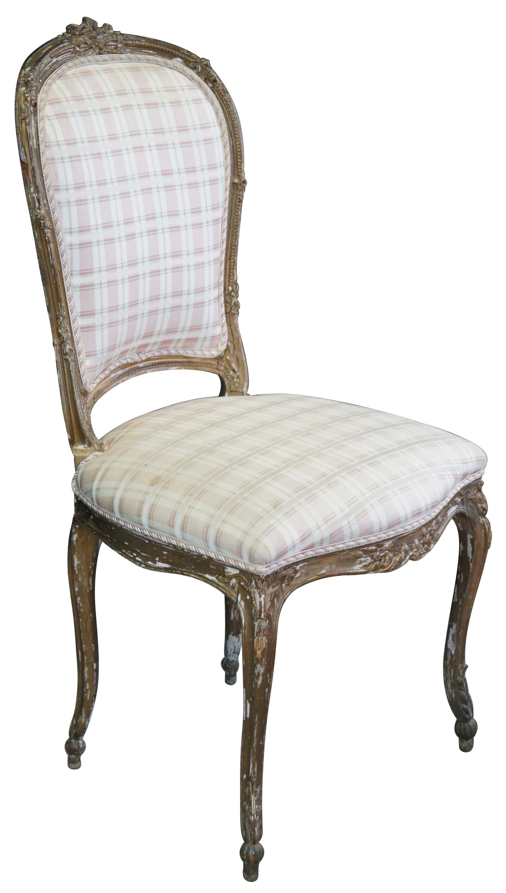 Antique French Louis XVI vanity chair featuring Neoclassical styling with carved ribbon crest, beaded and foliate accents, and serpentine legs with cabriole feet.

Measures: 18