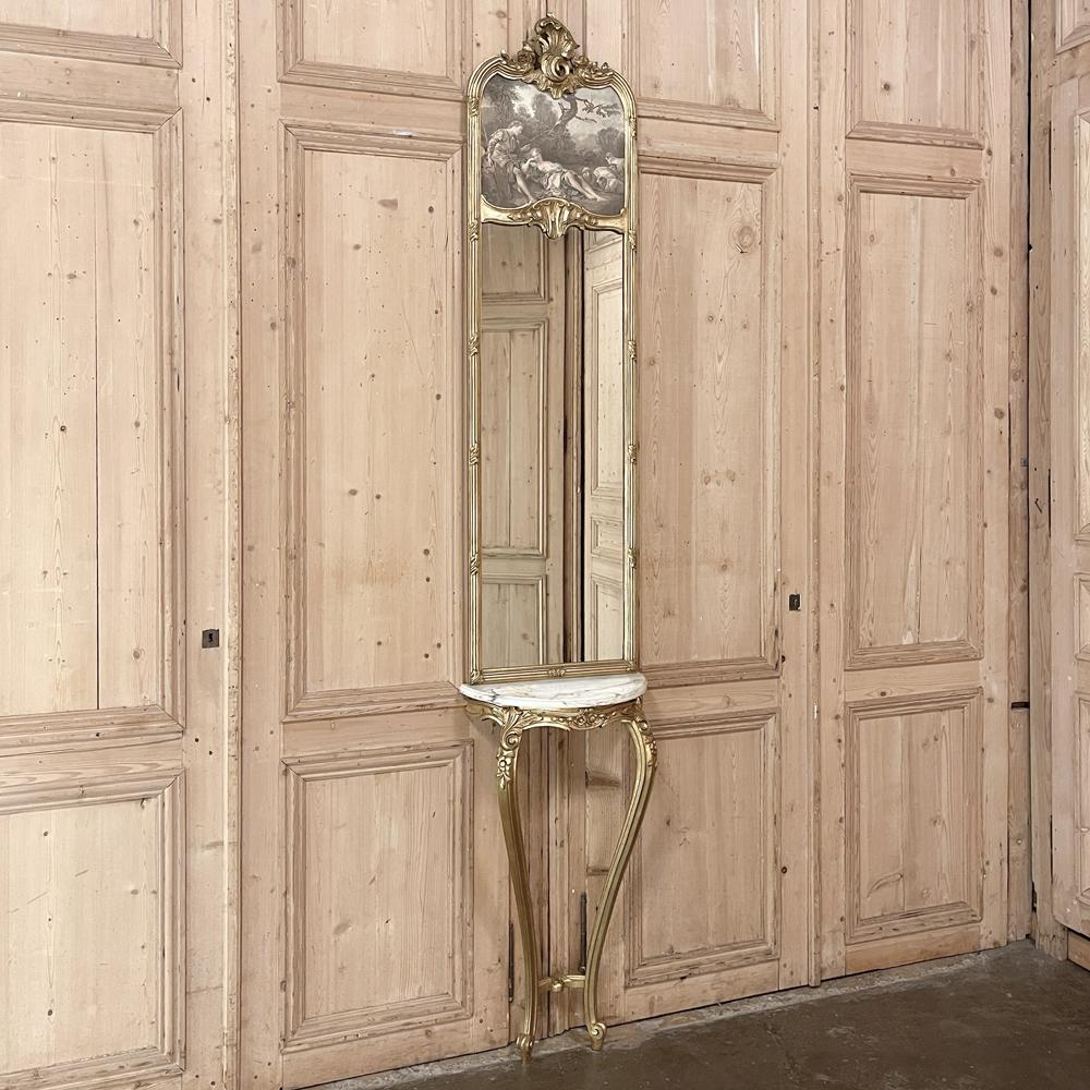 Antique French Louis XVI giltwood marble top console with Trumeau mirror is a graceful way to adorn an entryway, hall or stairwell landing! Consisting of a demilune marble top console below and a tall trumeau with generously sized mirror above, it