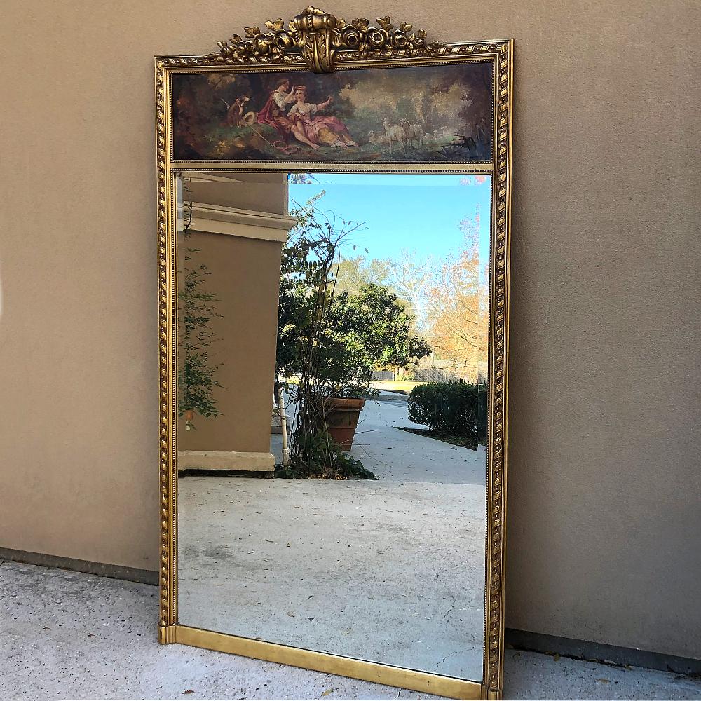 Antique French Louis XVI giltwood trumeau is a magnificent way to add Classic, timeless elegance to any room! Featuring a spiral ribbon bordering on the left, right and top, it has been crowned with a gorgeous heraldic crest at the center, flanked