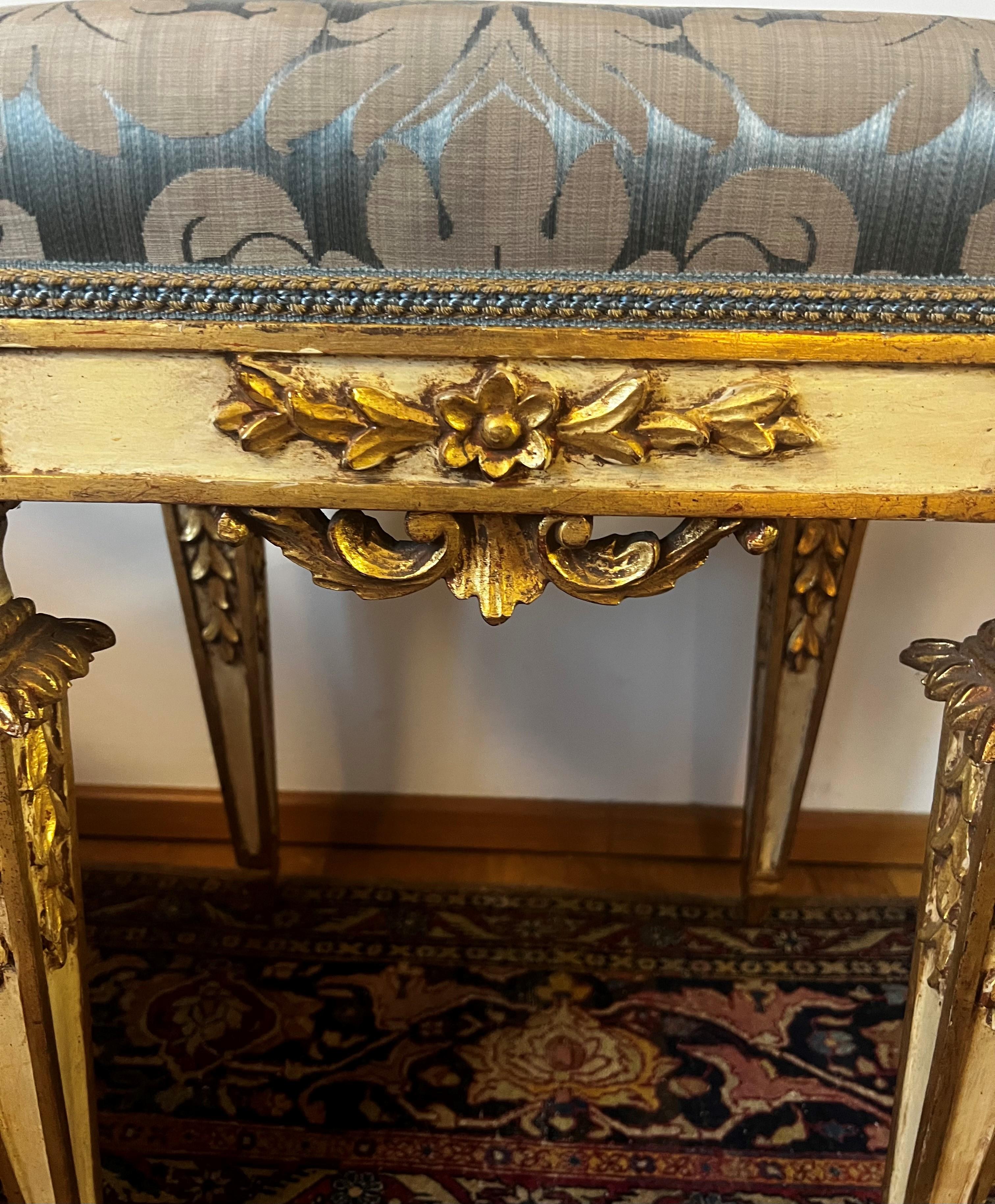 This elegant and decorative 18th century Louis XVI Stool or Tabouret has an original chalk-white painted surface, beautiful gilt details and wonderful old patina. This is an extraordinary piece of furniture, carved with style and upholstered with