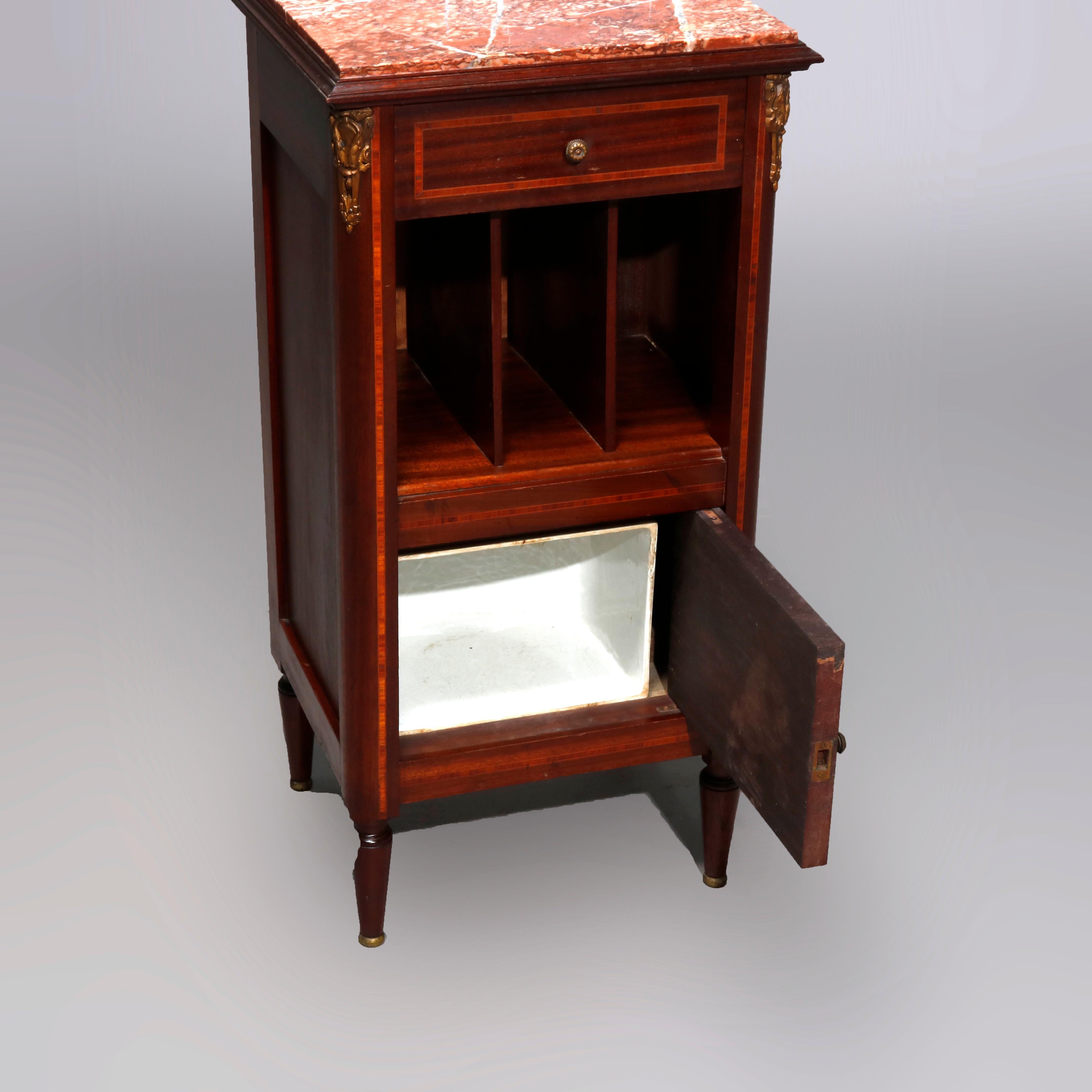 Antique French Louis XVI mahogany side stand with marble-top over satinwood banded case having single drawer, slotted shelf and lower marble lined cabinet, foliate cast ormolu throughout and raised on tapered legs, 20th century

Measures: 33