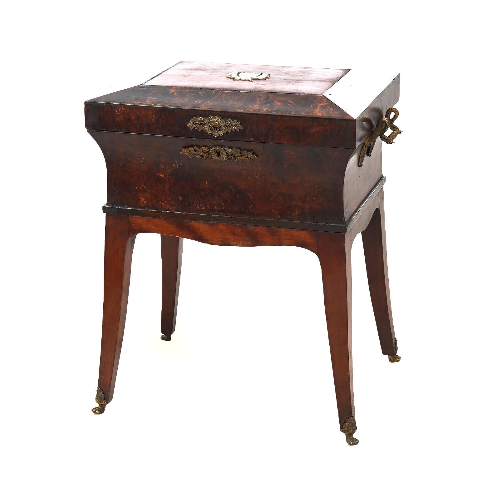 An antique French Louis XVI sewing box or jewel chest offers oliv wood construction with faceted lid having inlaid coat of arms, raised on slightly splayed legs, c1800

Measures - 22