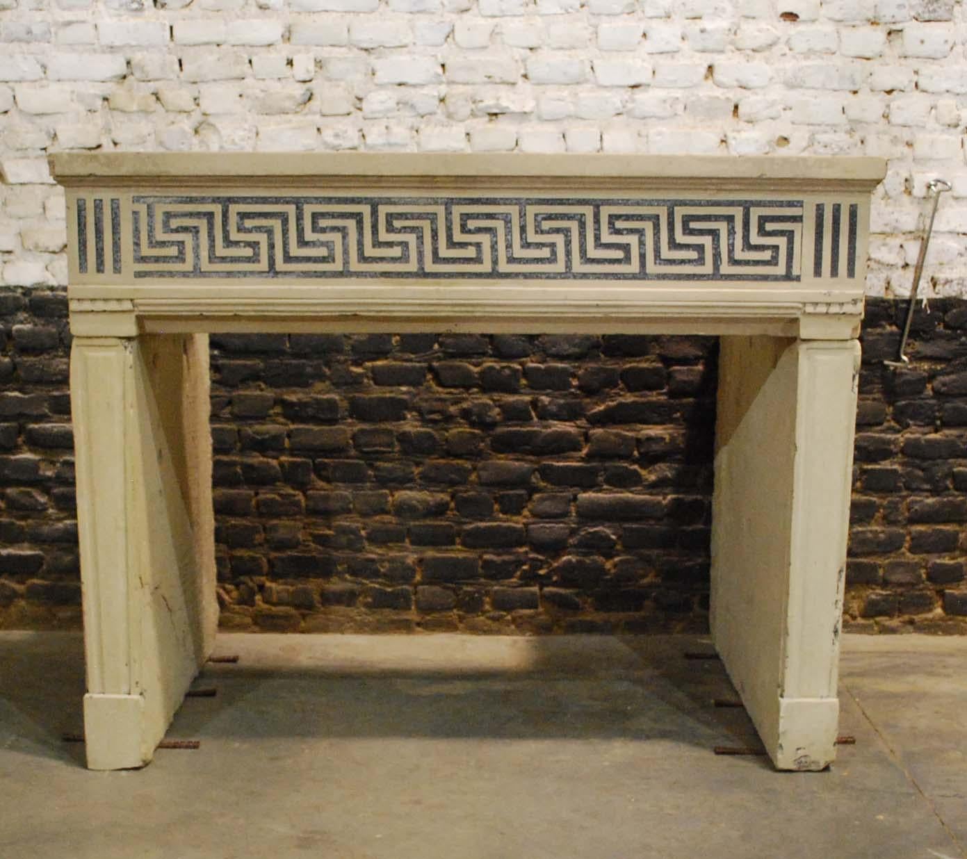 This beautiful French fireplace is carved from hard limestone. The frieze is decorated with an ancient geometrical Greek Meander pattern. Meander of meandros is a decorative border constructed from a continuous line, shaped into a repeated motif. It
