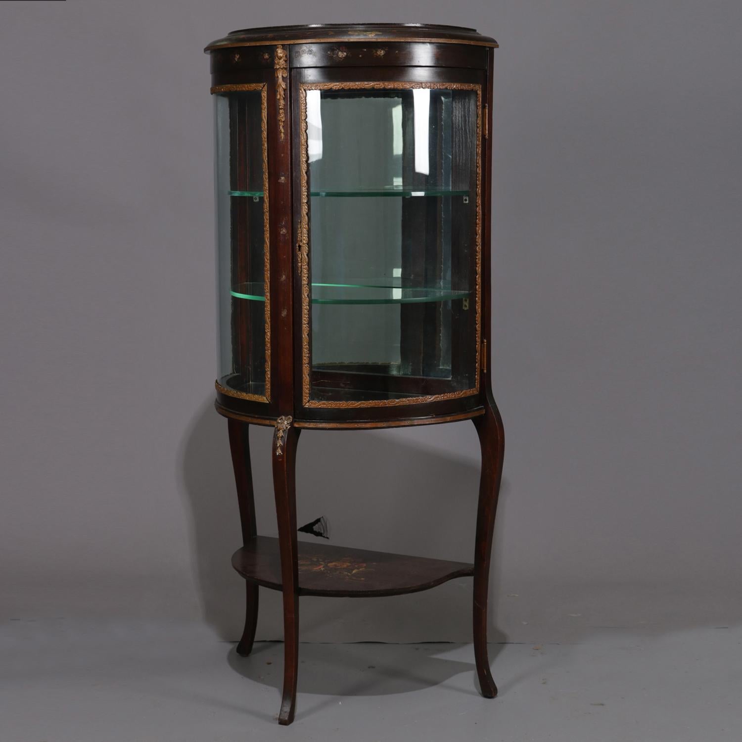 Antique French Louis XVI mahogany vitrine features Demilune form with bent glass and single door opening to mirrored interior with glass shelving, seated on cabriole legs, ormolu mounts and hand painted decoration throughout, circa
