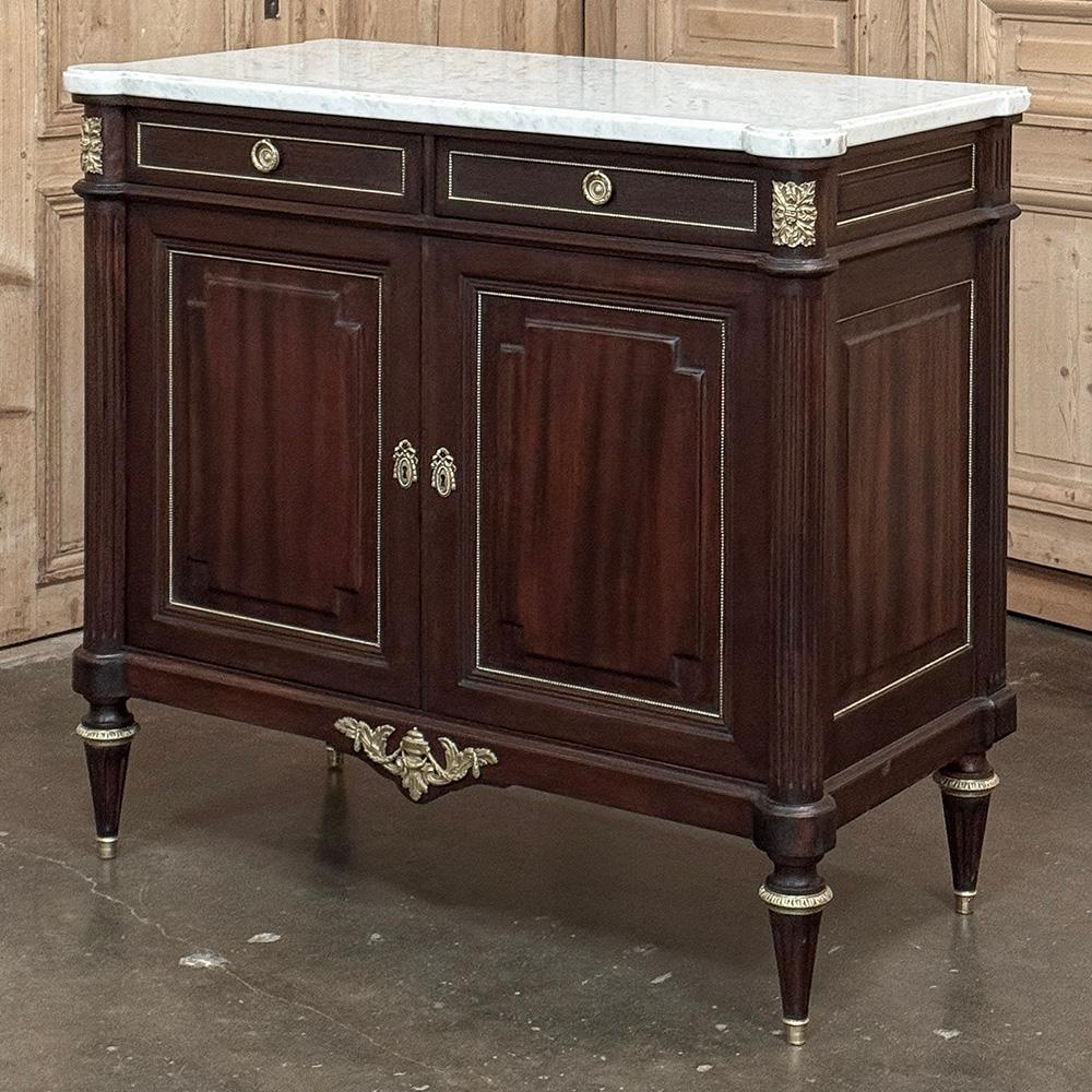 Antique French Louis XVI Mahogany Buffet with Carrara Marble exudes timeless style and opulence worthy of the King himself!  Hand-crafted from exquisite imported mahogany, it features a neoclassical architecture with its requisite rectilinear form