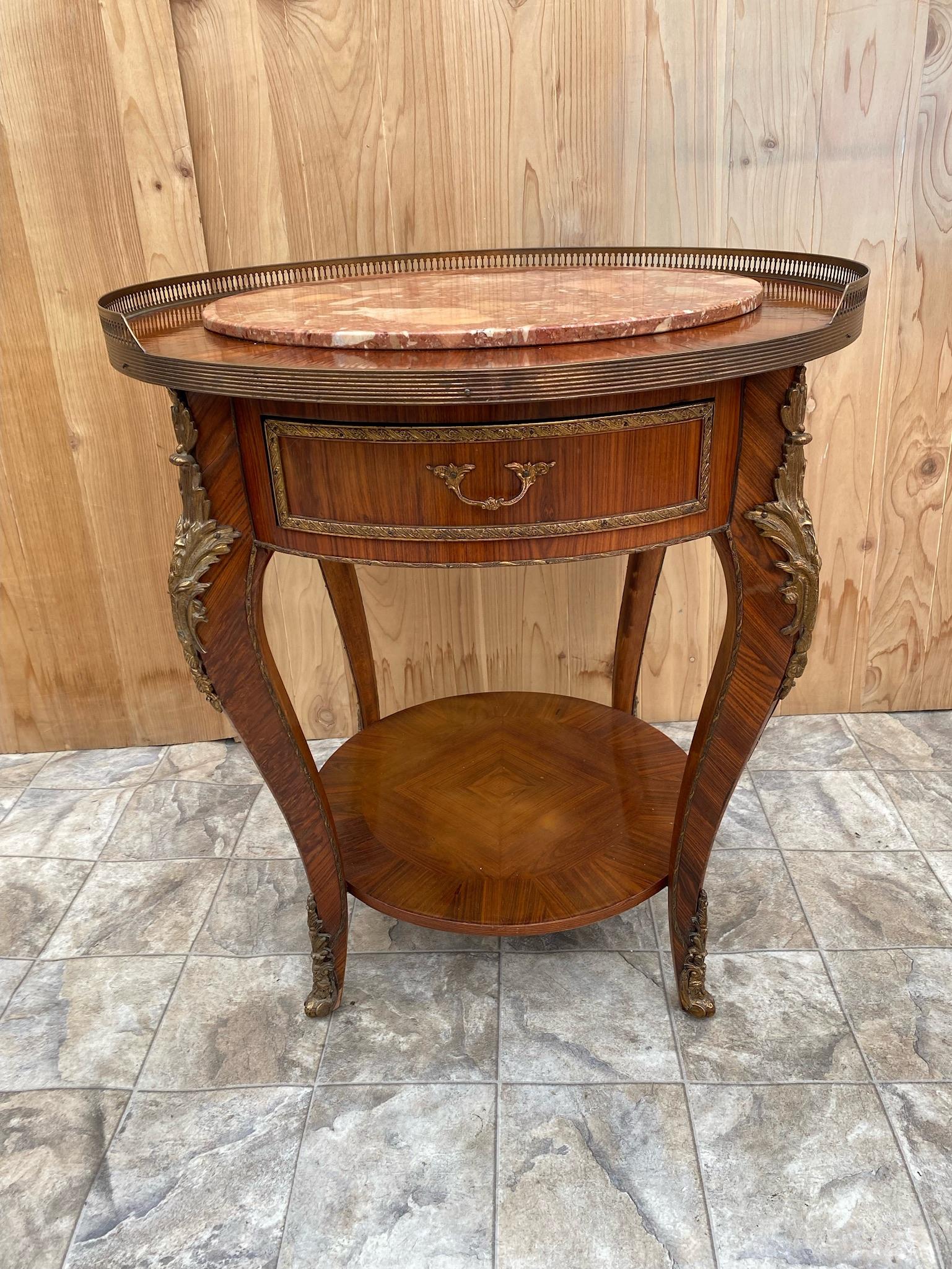 Antique French Louis XVI Bronze Ormolu Mounted Trim and Top Gallery with Inlaid Marble Top Cocktail/Occasional Table

Gorgeous Antique French Mahogany Louis XVI Cocktail Table with a Single Drawer, Two Tier Bronze Ormolu Mounted Top Trim and Top