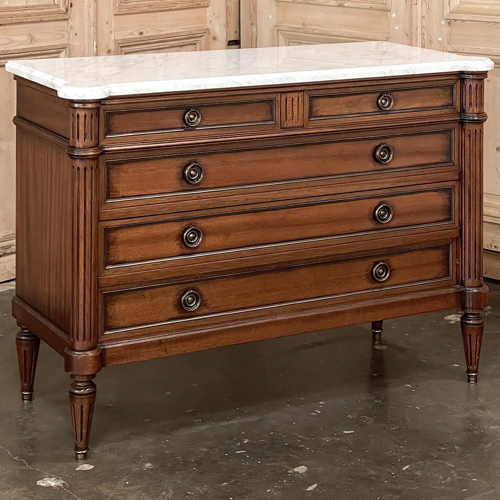 Antique French Louis XVI Mahogany Commode with Carrara Marble Top is truly a classic! Inspired by the architecture of the ancient Greeks and Romans, this piece was crafted from fine imported mahogany, and features two small drawers at top with three