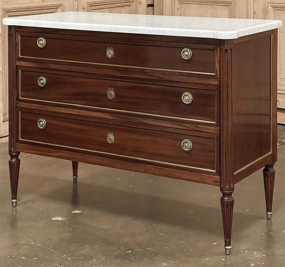 Antique French Louis XVI Mahogany Commode with Carrara Marble Top is truly a classic!  Inspired by the architecture of the ancient Greeks and Romans, this piece was crafted from fine imported mahogany, and features three full width drawers combined