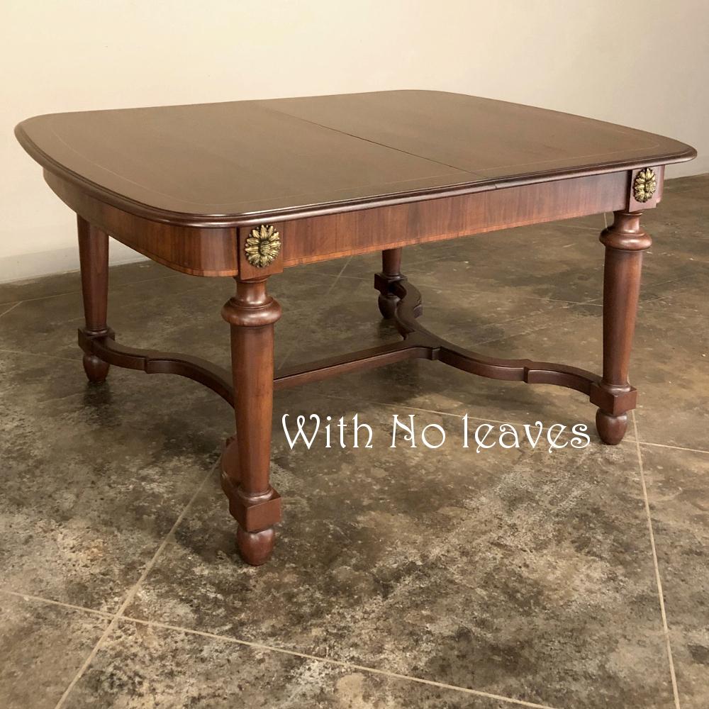 Antique French Louis XVI Mahogany table with Ormolu is an elegant way to display, dine, or play! Tailored lines ensure it will complement most any decor, and the beauty of the heavy cast bronze sunflower rosette mounts cannot be denied! Crafted from