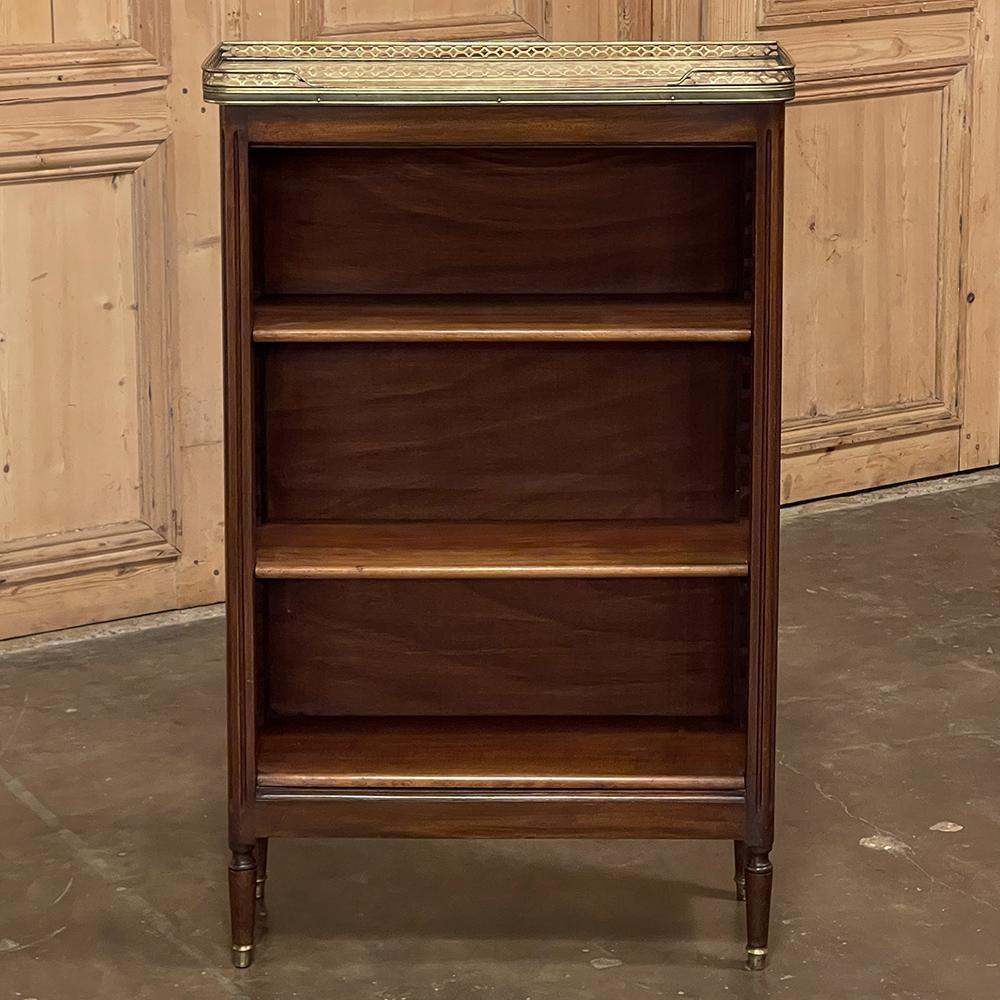 Antique French Louis XVI Mahogany Marble Top Petite Open Bookshelf is a marvelous expression of the style, rendered on a diminutive scale perfect for a cozy spot, apartment or townhome! Hand-crafted from exotic imported mahogany, it features a