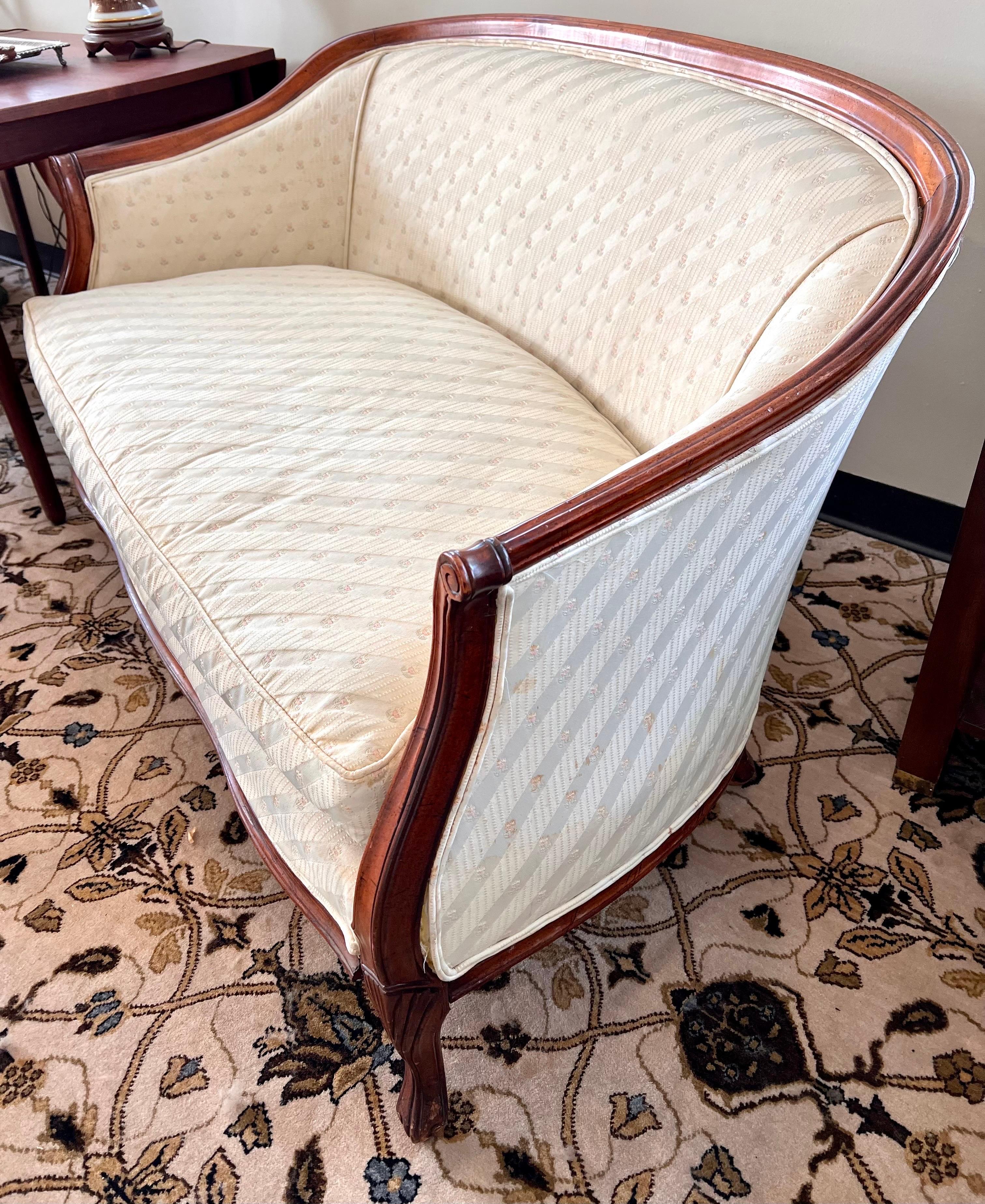 Lovely French Louis XVI style mahogany settee upholstered in a cream print fabric. Single down cushion.