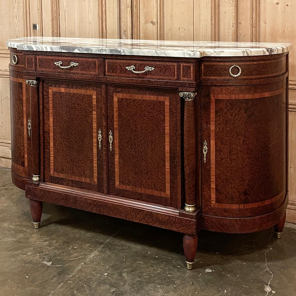 Antique French Louis XVI Marble Top Burl Wood Buffet is an elegant expression of the neoclassical form, rendered in exquisitely veined contoured and beveled marble, exotic and rare burl woods and cast bronze to create an unmistakable impression in