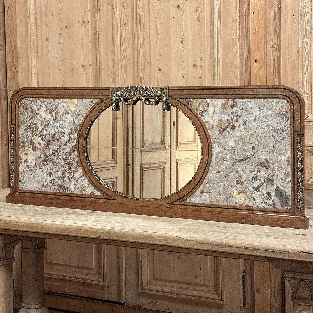 Antique French Louis XVI Neoclassical Mantel Mirror with Marble & Bronze Mounts is the perfect choice for tall mantels, broad surfaces, over cased openings, and more.  Hand-crafted from solid oak, the frame exhibits architecture influenced by the