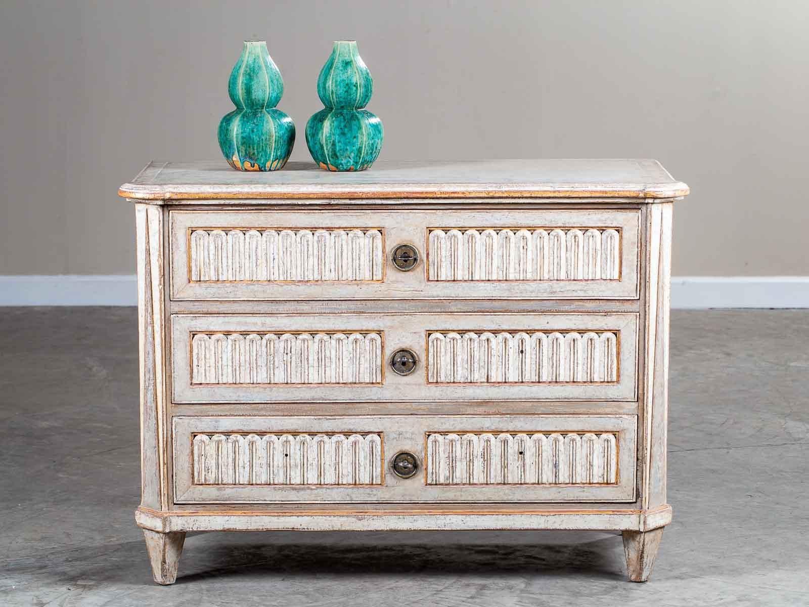 A striking neoclassical antique French painted and carved chest of drawers from France, circa 1790. The exceptional detail on this antique French chest makes it quite desirable as the cabinetmaker who created the design proved adept at balance,