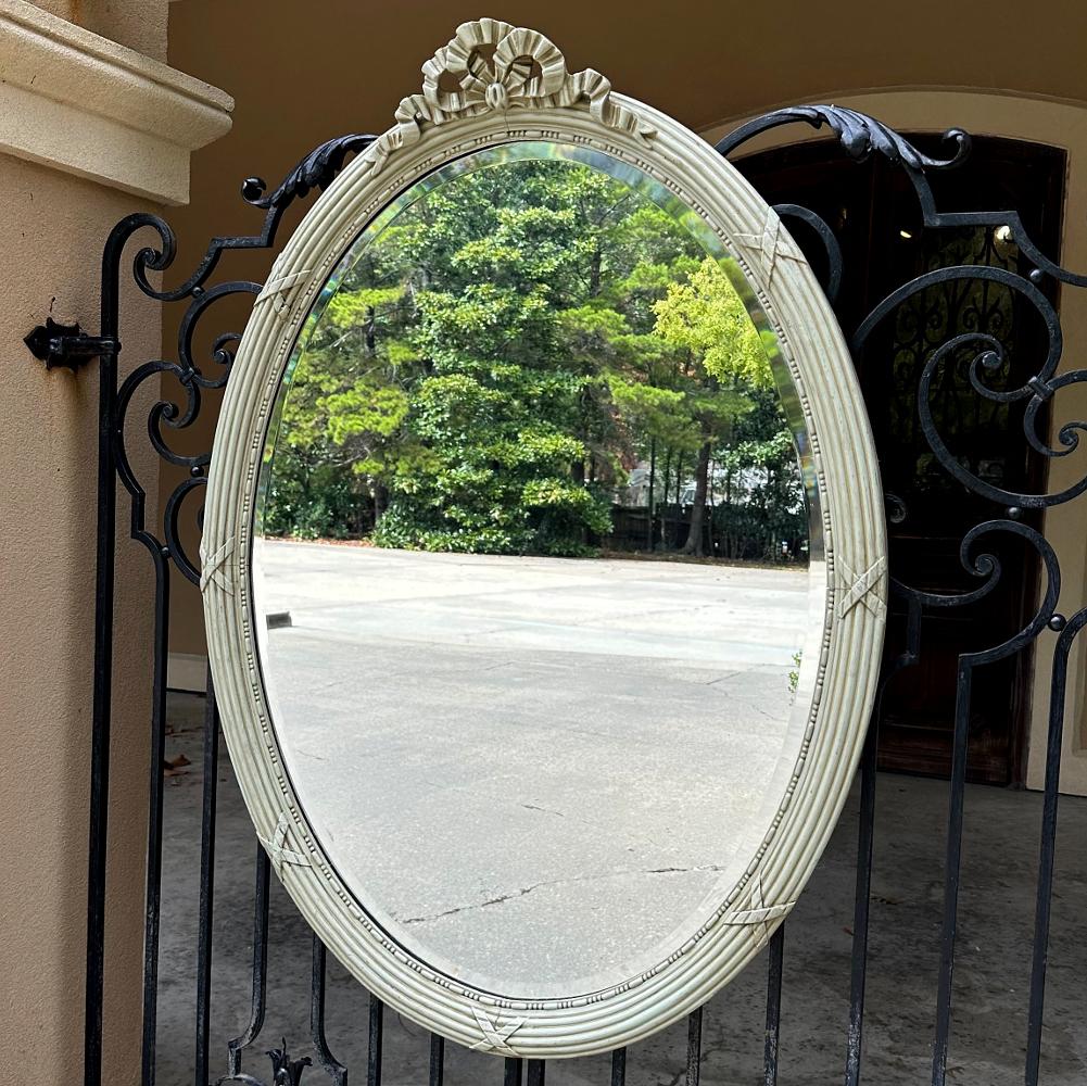 Antique French Louis XVI Neoclassical Painted Oval Mirror is ideal for a classical look with a soft, patinaed painted finish that is easy on the eyes.  An almost imperceptible olive tint to the painted finish adds natural richness.  On top we see