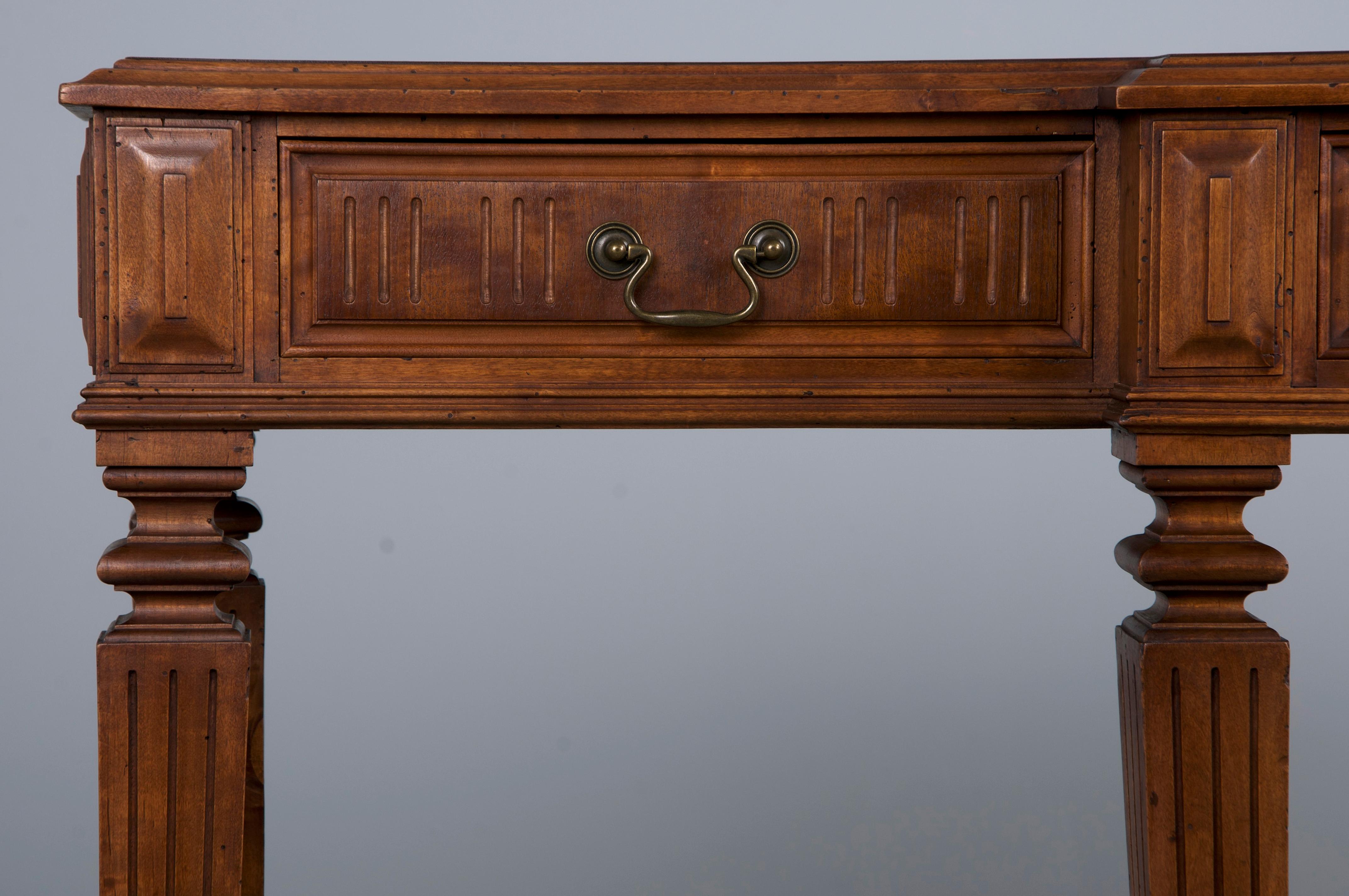 An elegant late 19th-century French console or sofa table crafted in the Louis XVI Neoclassical style, sourced from Provence, France. Beautifully hand-carved from mahogany, it features a narrow profile and a naturally aged patina with rich brown
