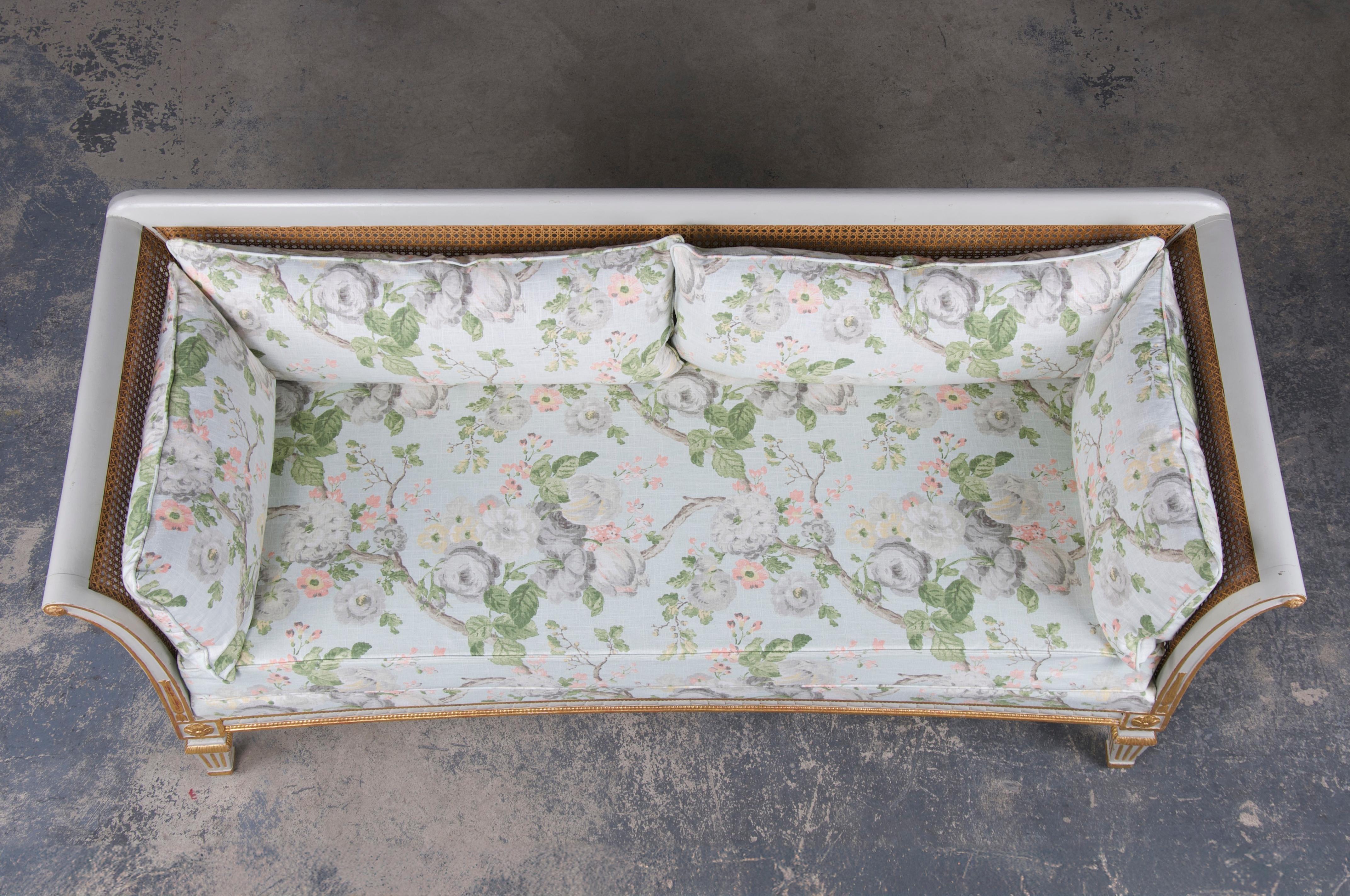 Fatto a mano Antique French Neoclassical Style Painted Cane Back Loveseat W/ Floral Linen in vendita