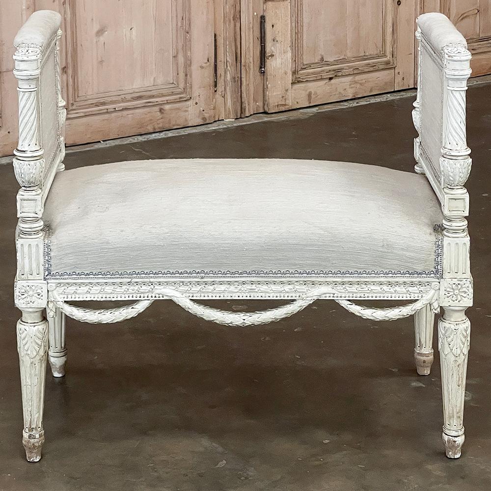 Antique French Louis XVI Neoclassical Upholstered Painted Armbench ~ Vanity Bench possesses enough classical design and embellishment to be the epitome of the movement! The upholstery was designed to be neutral yet comfortable, with firmly stuffed