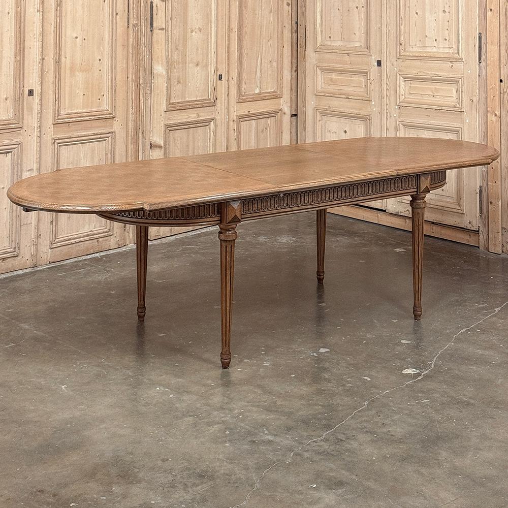 Antique French Louis XVI Oak Parquet Dining Table with Pop-Up Leaf is an ingenious design that will serve your family for many years to come.  Crafted from solid oak with parquet on top, the top is made of two halves that slide open to reveal a