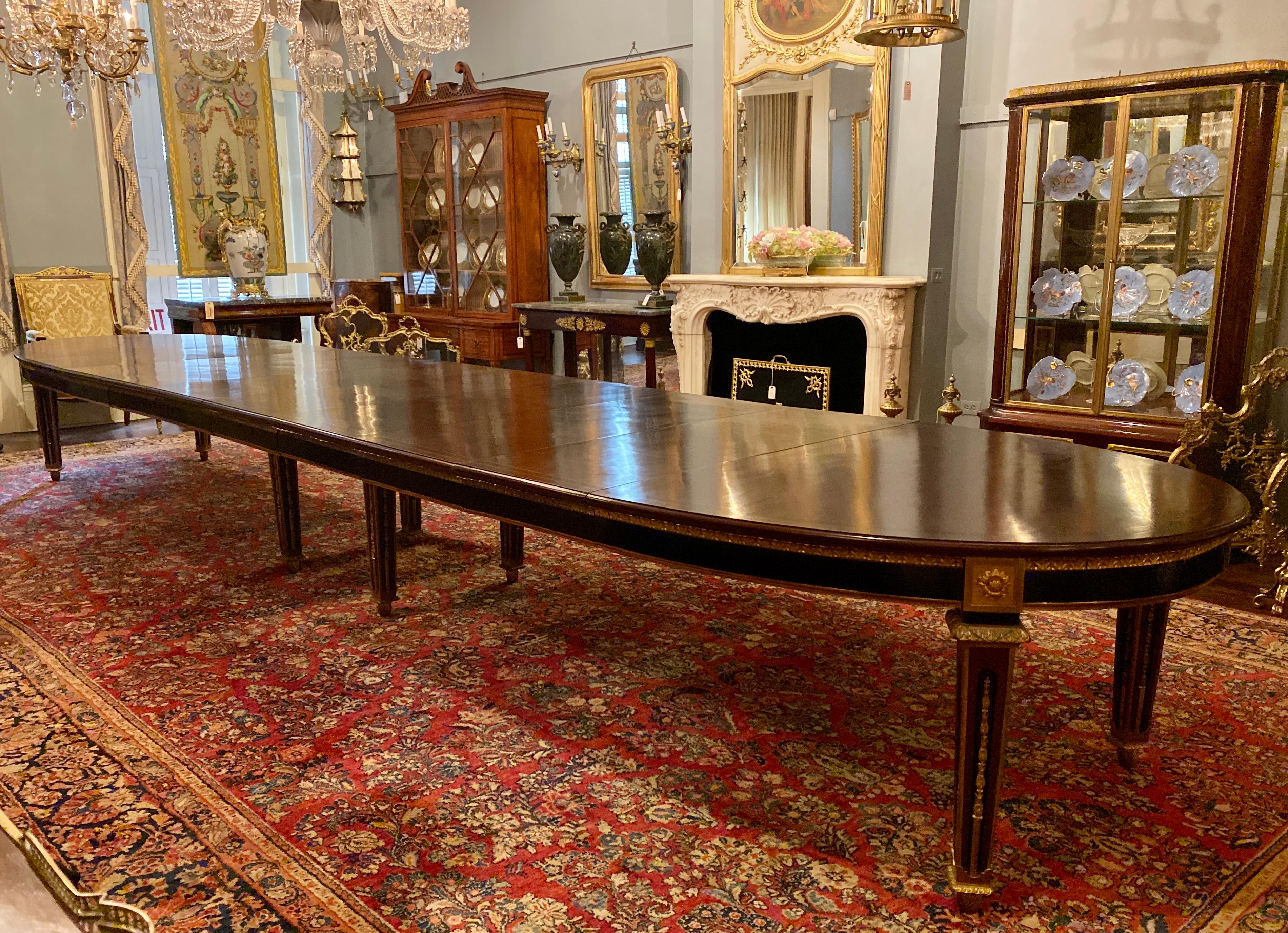 Exceptional size antique French Louis XVI ormolu-mounted mahogany dining table, circa 1860-1870.
19 1/2 feet (234 in) long when fully extended
8 leaves each 19