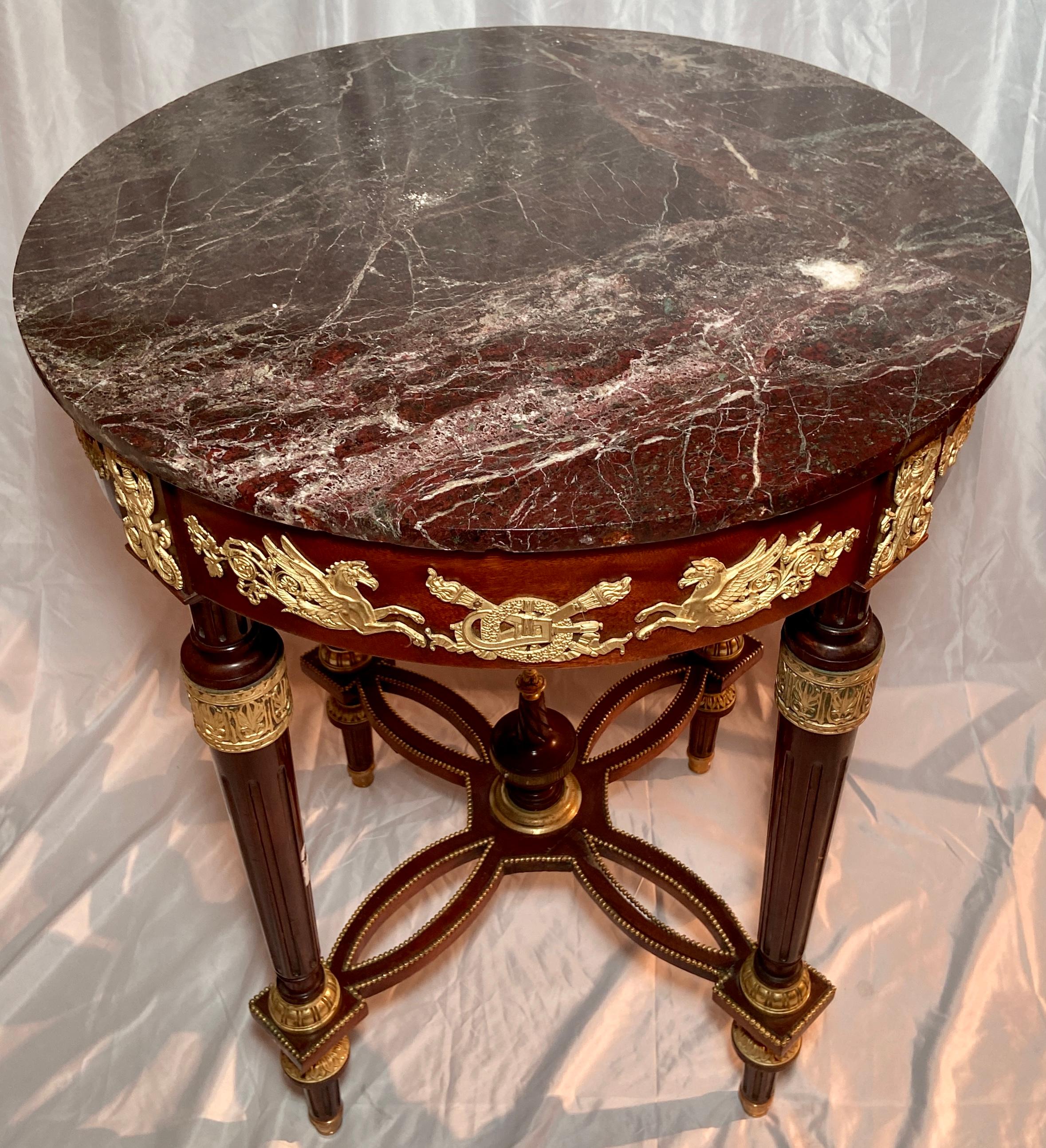 Antique French Louis XVI round mahogany occasional table with exceptional ormolu mounts and rouge marble top, Circa 1880.