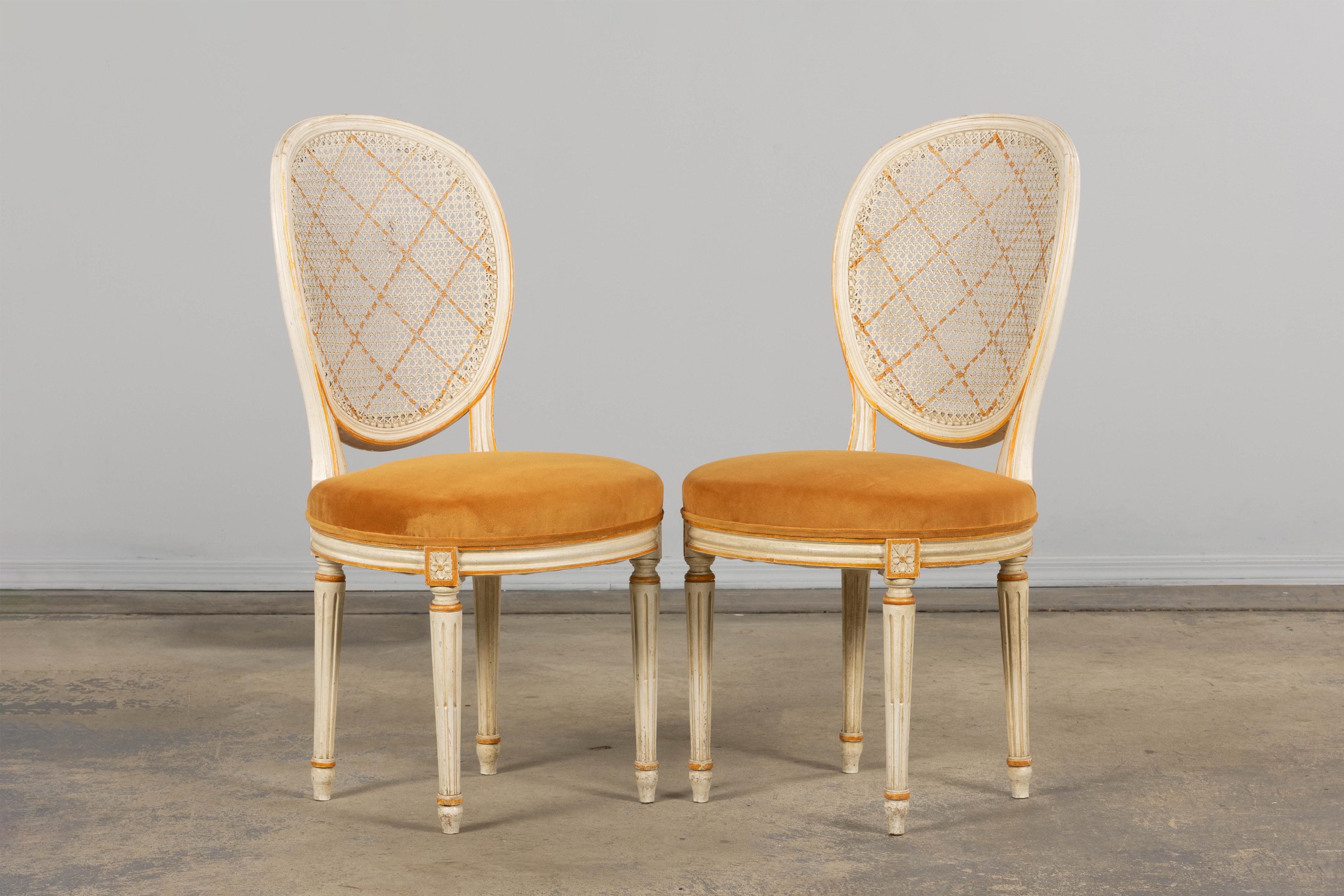 19th Century Antique French Louis XVI Painted Cane Back Accent Side Chairs W/ Marigold Velvet For Sale
