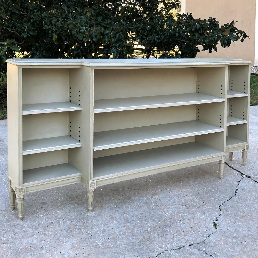 Antique French Louis XVI painted shallow bookcase features a nice, low profile as well as a shallow depth, making it a good choice for offices where space is at a premium, or perhaps in a passageway or hall! The painted finish has achieved a nice