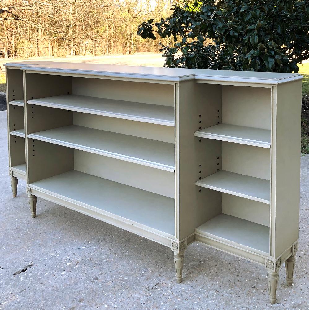 Antique French Louis XVI painted shallow bookcase features a nice, low profile as well as a shallow depth, making it a good choice for offices where space is at a premium, or perhaps in a passageway or hall! The painted finish has achieved a nice